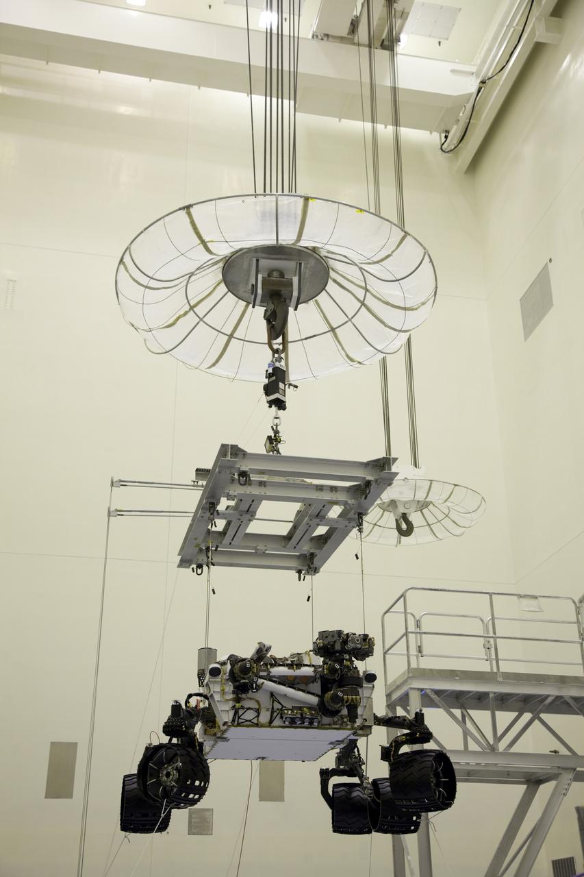 Cape Canaveral, Fla. -- Technicians, at the Payload Hazardous Servicing Facility at NASA's Kennedy Space Center in Florida, use an overhead crane to move NASA's Mars Science Laboratory (MSL) rover, known as Curiosity, to the high bay floor where the instrument mast and science boom will undergo deployment testing.             A United Launch Alliance Atlas V-541 configuration will be used to loft MSL into space. Curiosity’s 10 science instruments are designed to search for evidence on whether Mars has had environments favorable to microbial life, including chemical ingredients for life.  The unique rover will use a laser to look inside rocks and release its gasses so that the rover’s spectrometer can analyze and send the data back to Earth. MSL is scheduled to launch from Cape Canaveral Air Force Station in Florida Nov. 25 with a window extending to Dec. 18 and arrival at Mars Aug. 2012. For more information, visit http://www.nasa.gov/msl. Photo credit: NASA/Frankie Martin
