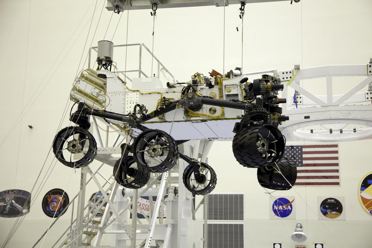 Cape Canaveral, Fla. -- Technicians, at the Payload Hazardous Servicing Facility at NASA's Kennedy Space Center in Florida, use an overhead crane to move NASA's Mars Science Laboratory (MSL) rover, known as Curiosity, to the high bay floor where the instrument mast and science boom will undergo deployment testing.             A United Launch Alliance Atlas V-541 configuration will be used to loft MSL into space. Curiosity’s 10 science instruments are designed to search for evidence on whether Mars has had environments favorable to microbial life, including chemical ingredients for life.  The unique rover will use a laser to look inside rocks and release its gasses so that the rover’s spectrometer can analyze and send the data back to Earth. MSL is scheduled to launch from Cape Canaveral Air Force Station in Florida Nov. 25 with a window extending to Dec. 18 and arrival at Mars Aug. 2012. For more information, visit http://www.nasa.gov/msl. Photo credit: NASA/Frankie Martin
