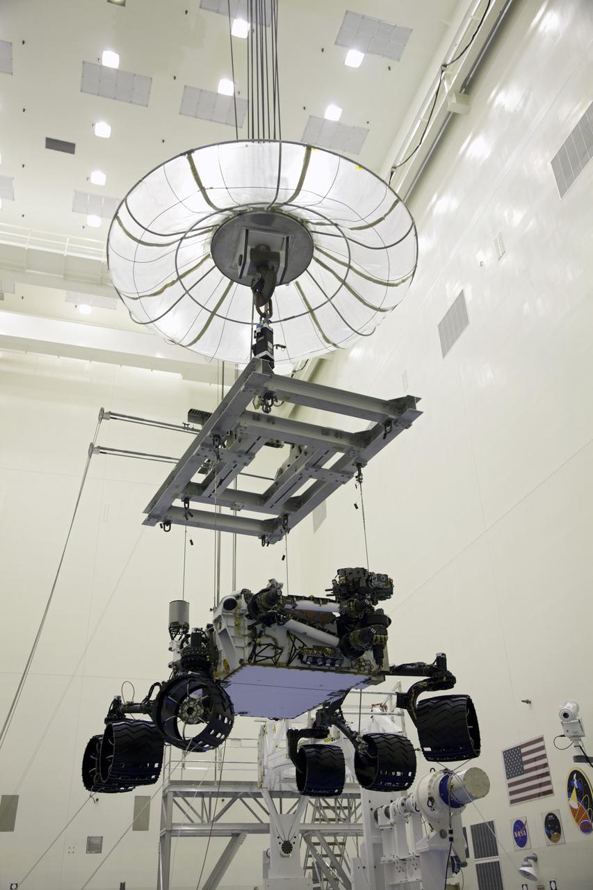 Cape Canaveral, Fla. -- Technicians, at the Payload Hazardous Servicing Facility at NASA's Kennedy Space Center in Florida, use an overhead crane to move NASA's Mars Science Laboratory (MSL) rover, known as Curiosity, to the high bay floor where the instrument mast and science boom will undergo deployment testing.             A United Launch Alliance Atlas V-541 configuration will be used to loft MSL into space. Curiosity’s 10 science instruments are designed to search for evidence on whether Mars has had environments favorable to microbial life, including chemical ingredients for life.  The unique rover will use a laser to look inside rocks and release its gasses so that the rover’s spectrometer can analyze and send the data back to Earth. MSL is scheduled to launch from Cape Canaveral Air Force Station in Florida Nov. 25 with a window extending to Dec. 18 and arrival at Mars Aug. 2012. For more information, visit http://www.nasa.gov/msl. Photo credit: NASA/Frankie Martin