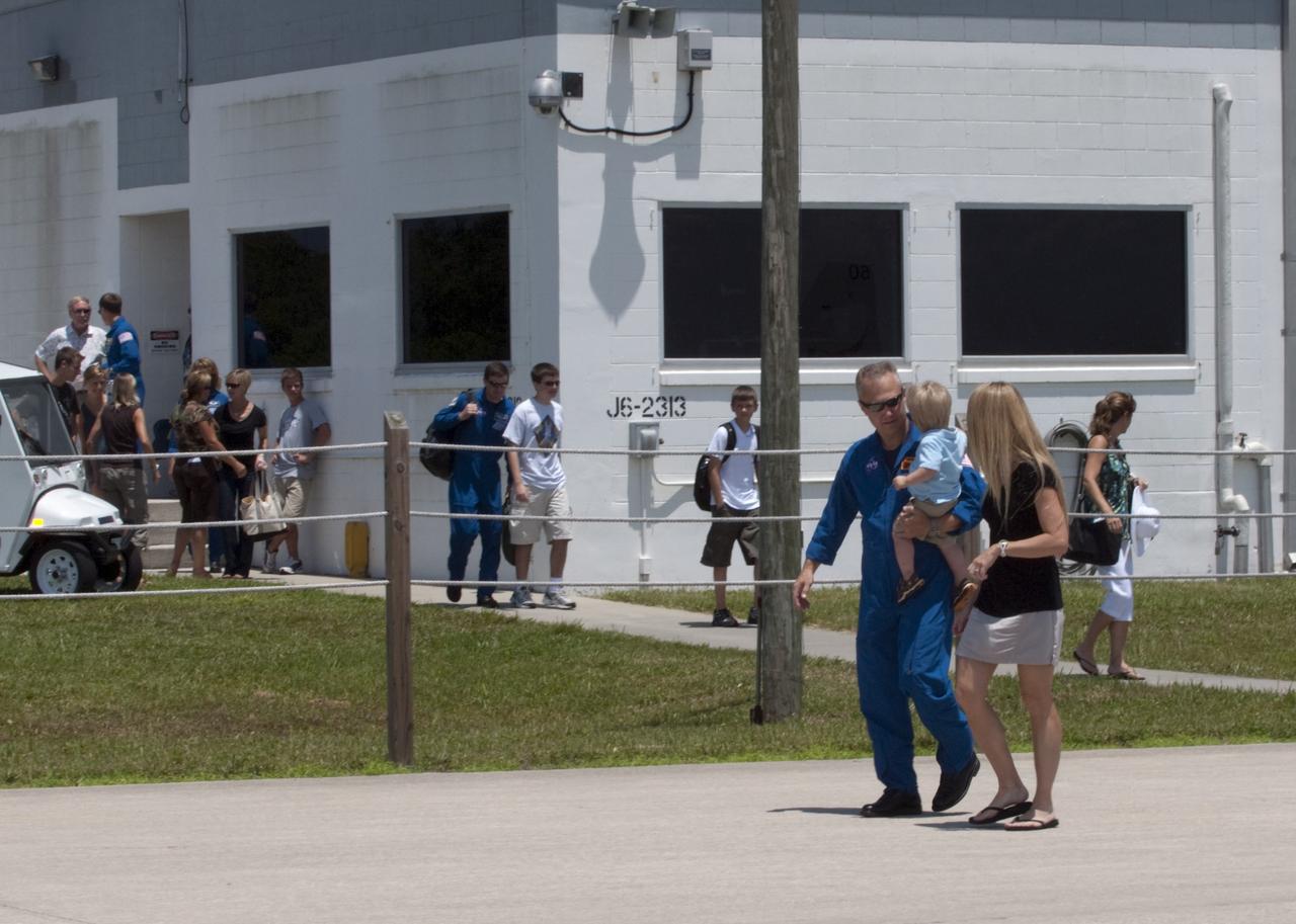 CAPE CANAVERAL, Fla. -- The STS-135 astronauts prepare to depart NASA's Kennedy Space Center in Florida to return to NASA's Johnson Space Center in Houston. Space shuttle Atlantis and its crew touched down on Kennedy's Shuttle Landing Facility runway 5:57 a.m., July 21, 2011, bringing a close to 30 years of space shuttle missions. Here, STS-135 Pilot Doug Hurley and his family walk toward a Gulfstream III jet that will take them back home.    Securing the space shuttle fleet's place in history, Atlantis marked the 26th nighttime landing of the Space Shuttle Program and the 78th landing at Kennedy. Atlantis and its crew delivered to the International Space Station the Raffaello multi-purpose logistics module packed with more than 9,400 pounds of spare parts, equipment and supplies that will sustain station operations for the next year. STS-135 was the 33rd and final flight for Atlantis and the final mission of the Space Shuttle Program. For more information, visit www.nasa.gov/mission_pages/shuttle/shuttlemissions/sts135/index.html. Photo credit: NASA/Kim Shiflett
