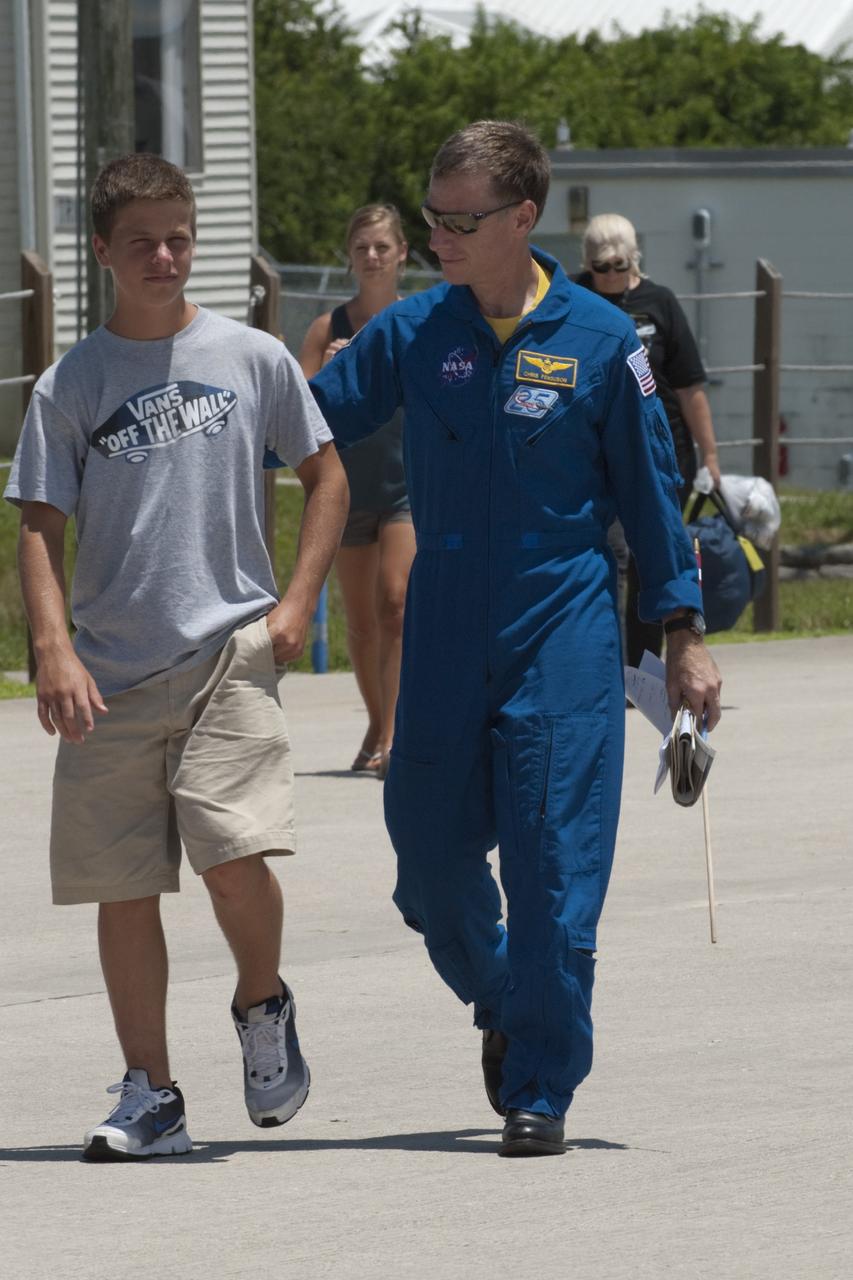 CAPE CANAVERAL, Fla. -- The STS-135 astronauts prepare to depart NASA's Kennedy Space Center in Florida to return to NASA's Johnson Space Center in Houston. Space shuttle Atlantis and its crew touched down on Kennedy's Shuttle Landing Facility runway 5:57 a.m., July 21, 2011, bringing a close to 30 years of space shuttle missions. Here, STS-135 Commander Chris Ferguson and his son walk toward a Gulfstream III jet that will take them back home. Securing the space shuttle fleet's place in history, Atlantis marked the 26th nighttime landing of the Space Shuttle Program and the 78th landing at Kennedy. Atlantis and its crew delivered to the International Space Station the Raffaello multi-purpose logistics module packed with more than 9,400 pounds of spare parts, equipment and supplies that will sustain station operations for the next year. STS-135 was the 33rd and final flight for Atlantis and the final mission of the Space Shuttle Program. For more information, visit www.nasa.gov/mission_pages/shuttle/shuttlemissions/sts135/index.html. Photo credit: NASA/Kim Shiflett