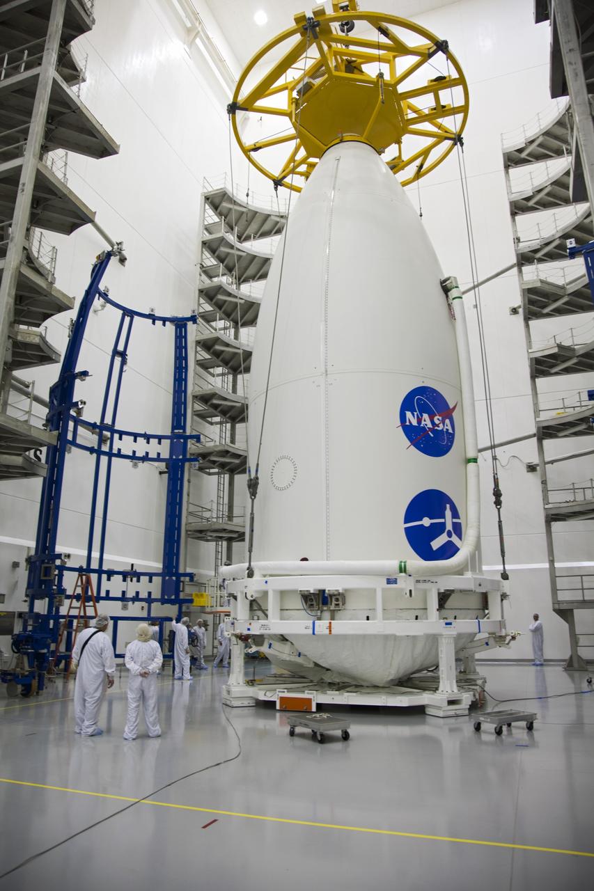 CAPE CANAVERAL, Fla. -- In the Astrotech payload processing facility near Kennedy Space Center in Florida, a lifting device rests atop the nose of the Atlas payload fairing enclosing the Juno spacecraft during operations to lift the spacecraft onto a transporter for its trip to Space Launch Complex 41.    The fairing will protect the spacecraft from the impact of aerodynamic pressure and heating during ascent and will be jettisoned once the spacecraft is outside the Earth's atmosphere. Juno is scheduled to launch aboard a United Launch Alliance Atlas V rocket from Cape Canaveral, Fla., Aug. 5.The solar-powered spacecraft will orbit Jupiter's poles 33 times to find out more about the gas giant's origins, structure, atmosphere and magnetosphere and investigate the existence of a solid planetary core. For more information, visit www.nasa.gov/juno. Photo credit: NASA/Frank Michaux