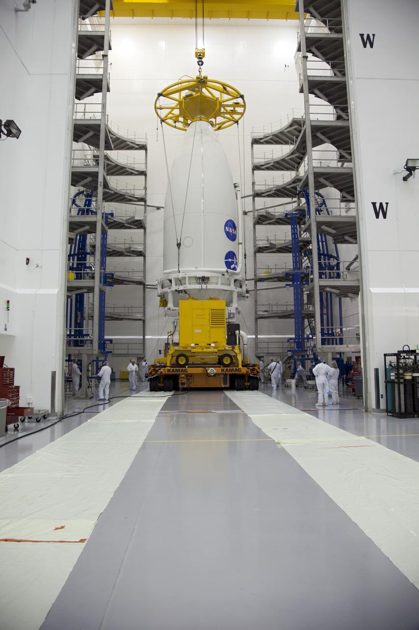 CAPE CANAVERAL, Fla. -- In the Astrotech payload processing facility near Kennedy Space Center in Florida, a lifting device lowers the Atlas payload fairing enclosing the Juno spacecraft onto a transporter during operations to move the spacecraft to Space Launch Complex 41. The fairing will protect the spacecraft from the impact of aerodynamic pressure and heating during ascent and will be jettisoned once the spacecraft is outside the Earth's atmosphere. Juno is scheduled to launch aboard a United Launch Alliance Atlas V rocket from Cape Canaveral, Fla., Aug. 5.The solar-powered spacecraft will orbit Jupiter's poles 33 times to find out more about the gas giant's origins, structure, atmosphere and magnetosphere and investigate the existence of a solid planetary core. For more information, visit www.nasa.gov/juno. Photo credit: NASA/Frank Michaux