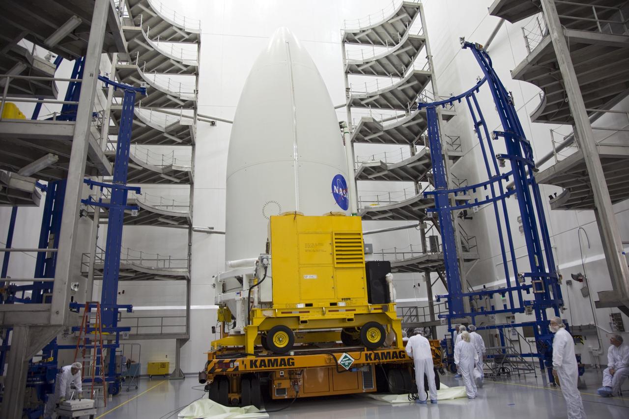 CAPE CANAVERAL, Fla. -- In the Astrotech payload processing facility near Kennedy Space Center in Florida, the Atlas payload fairing enclosing the Juno spacecraft is secured on a transporter and ready for its trip to Space Launch Complex 41.    The fairing will protect the spacecraft from the impact of aerodynamic pressure and heating during ascent and will be jettisoned once the spacecraft is outside the Earth's atmosphere. Juno is scheduled to launch aboard a United Launch Alliance Atlas V rocket from Cape Canaveral, Fla., Aug. 5.The solar-powered spacecraft will orbit Jupiter's poles 33 times to find out more about the gas giant's origins, structure, atmosphere and magnetosphere and investigate the existence of a solid planetary core. For more information, visit www.nasa.gov/juno. Photo credit: NASA/Frank Michaux