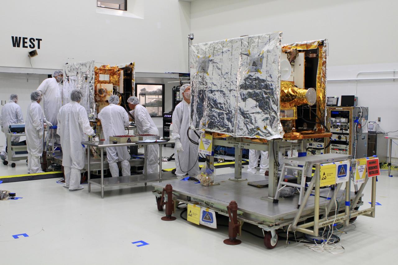 CAPE CANAVERAL, Fla. -- NASA's twin Gravity Recovery and Interior Laboratory spacecraft are positioned side-by-side in Astrotech Space Operation's payload processing facility in Titusville, Fla.  Lockheed Martin technicians are performing testing the solar arrays on GRAIL-A to ensure that they will function as planned during the mission.    The electrical power subsystem on each of GRAIL's twin spacecraft includes two solar arrays and a lithium ion battery. Each solar array is capable of producing no less than 700 watts. They will be deployed shortly after separation from the launch vehicle and remain fixed throughout the mission. GRAIL will fly in tandem orbits around the moon for several months to measure its gravity field. GRAIL's primary science objectives are to determine the structure of the lunar interior, from crust to core, and to advance understanding of the thermal evolution of the moon.  Launch aboard a United Launch Alliance Delta II rocket from Space Launch Complex 17B on Cape Canaveral Air Force Station is scheduled for Sept. 8.  For more information, visit http://www.nasa.gov/grail. Photo credit: NASA/Frankie Martin