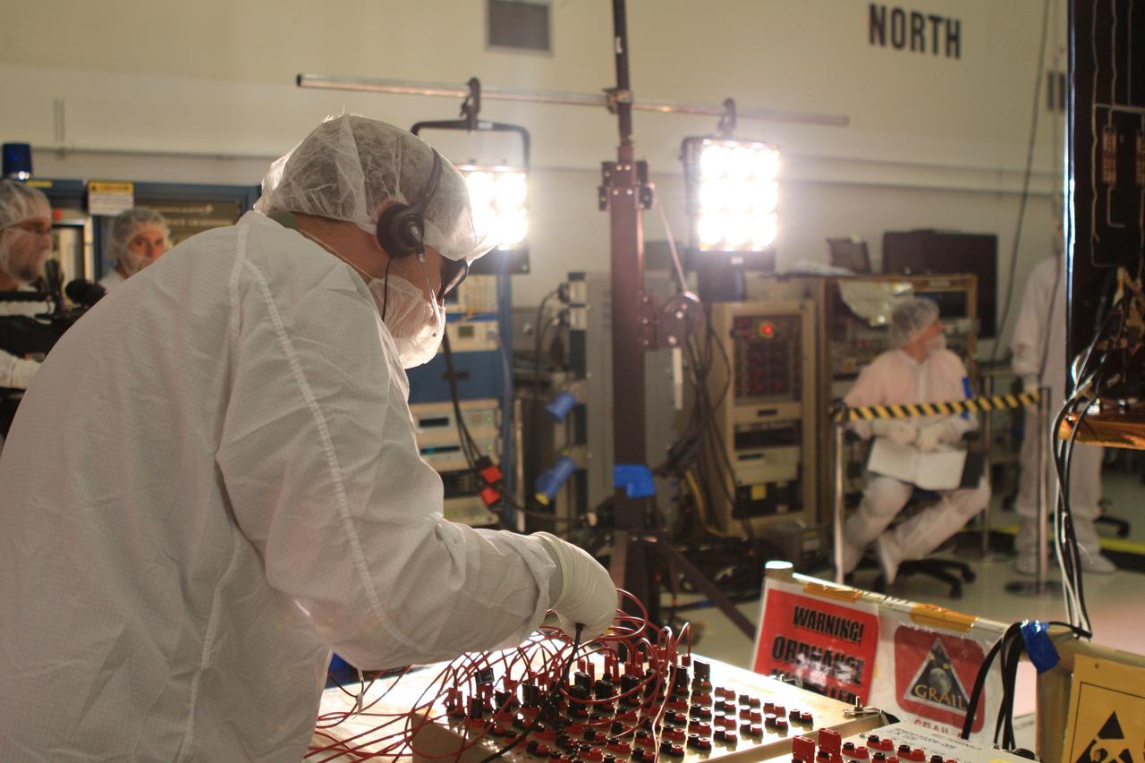 CAPE CANAVERAL, Fla. -- A Lockheed Martin technician in Astrotech Space Operation's payload processing facility in Titusville, Fla., tests the solar arrays on NASA's Gravity Recovery and Interior Laboratory-A, or GRAIL-A, spacecraft to ensure that they will function as planned during the mission.    The electrical power subsystem on each of GRAIL's twin spacecraft includes two solar arrays and a lithium ion battery. Each solar array is capable of producing no less than 700 watts. They will be deployed shortly after separation from the launch vehicle and remain fixed throughout the mission. GRAIL will fly in tandem orbits around the moon for several months to measure its gravity field. GRAIL's primary science objectives are to determine the structure of the lunar interior, from crust to core, and to advance understanding of the thermal evolution of the moon.  Launch aboard a United Launch Alliance Delta II rocket from Space Launch Complex 17B on Cape Canaveral Air Force Station is scheduled for Sept. 8.  For more information, visit http://www.nasa.gov/grail. Photo credit: NASA/Frankie Martin