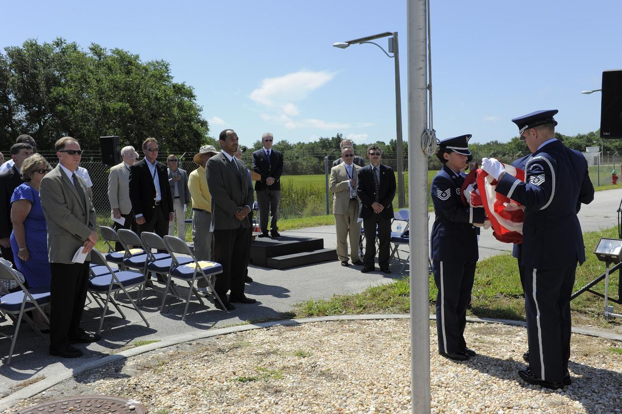 CAPE CANAVERAL, Fla. -- At the Merritt Island Launch Annex (MILA) Spaceflight Tracking and Data Network Station at NASA's Kennedy Space Center in Florida, the Patrick Air Force Base Color Guard folds the U.S. flag for the last time at a closing ceremony recognizing the station's 45 years of service.    The station was originally established by NASA's Goddard Space Flight Center as one of 17 Space Flight Tracking and Data Network stations around the world. Commissioned for the Apollo Program, the first launch it supported was the Apollo/Saturn 203 test flight from Launch Complex 37 on July 5, 1966. It also provided orbital support for low earth-orbiting scientific satellites. In recent history, the station has been used almost exclusively for space shuttle launch and landing support. Following the final launch and landing of the Space Shuttle Program in July 2011, the MILA station is officially decommissioned. For more information, visit http://www.nasa.gov/centers/kennedy/pdf/167424main_MILA-08C.pdf. Photo credit: NASA/Kim Shiflett
