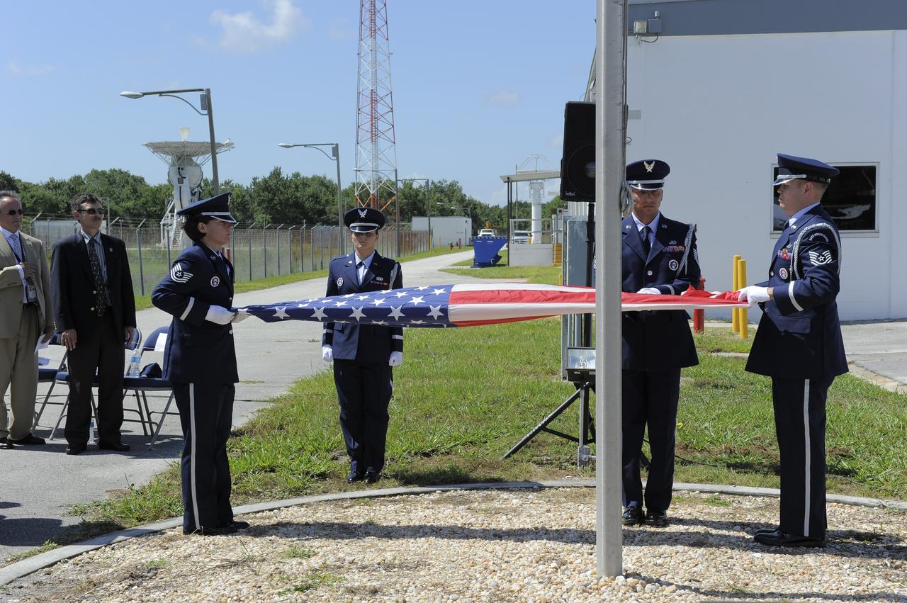 CAPE CANAVERAL, Fla. -- At the Merritt Island Launch Annex (MILA) Spaceflight Tracking and Data Network Station at NASA's Kennedy Space Center in Florida, the Patrick Air Force Base Color Guard folds the U.S. flag for the last time at a closing ceremony recognizing the station's 45 years of service.    The station was originally established by NASA's Goddard Space Flight Center as one of 17 Space Flight Tracking and Data Network stations around the world. Commissioned for the Apollo Program, the first launch it supported was the Apollo/Saturn 203 test flight from Launch Complex 37 on July 5, 1966. It also provided orbital support for low earth-orbiting scientific satellites. In recent history, the station has been used almost exclusively for space shuttle launch and landing support. Following the final launch and landing of the Space Shuttle Program in July 2011, the MILA station is officially decommissioned. For more information, visit http://www.nasa.gov/centers/kennedy/pdf/167424main_MILA-08C.pdf. Photo credit: NASA/Kim Shiflett
