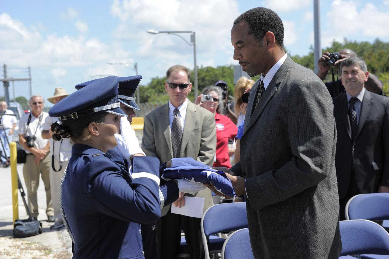 CAPE CANAVERAL, Fla. -- At the Merritt Island Launch Annex (MILA) Spaceflight Tracking and Data Network Station at NASA's Kennedy Space Center in Florida, the Patrick Air Force Base Color Guard presents the U.S. flag which flew over the station to David Carter, Near Earth Network project manager at Goddard Space Flight Center, during a closing ceremony recognizing the station's 45 years of service.  The flag will be displayed in a Network Integration Center display cabinet at Goddard. The station was originally established by NASA's Goddard Space Flight Center as one of 17 Space Flight Tracking and Data Network stations around the world. Commissioned for the Apollo Program, the first launch it supported was the Apollo/Saturn 203 test flight from Launch Complex 37 on July 5, 1966. It also provided orbital support for low earth-orbiting scientific satellites. In recent history, the station has been used almost exclusively for space shuttle launch and landing support. Following the final launch and landing of the Space Shuttle Program in July 2011, the MILA station is officially decommissioned. For more information, visit http://www.nasa.gov/centers/kennedy/pdf/167424main_MILA-08C.pdf. Photo credit: NASA/Kim Shiflett