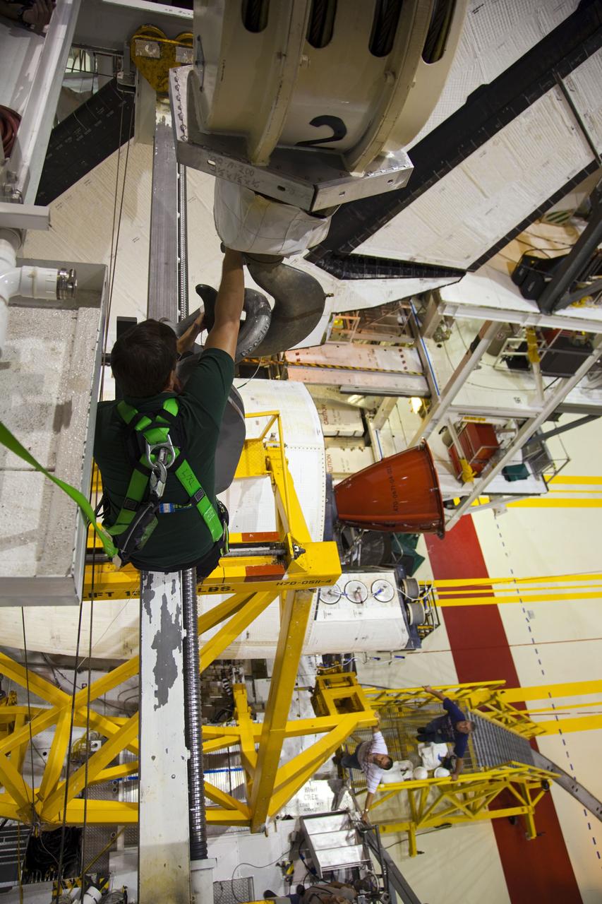CAPE CANAVERAL, Fla. -- In Orbiter Processing Facility-1 at NASA’s Kennedy Space Center in Florida, an overhead crane is moved into place around shuttle Endeavour’s left-hand orbital maneuvering system, or OMS, pod, to begin removal of the component.The work is part of Endeavour’s transition and retirement processing. The spacecraft is being prepared for public display at the California Science Center in Los Angeles. Endeavour flew 25 missions, spent 299 days in space, orbited Earth 4,671 times and traveled 122, 883, 151 miles over the course of its 19-year career. Endeavour’s STS-134 and final mission was completed after landing on June 1, 2011. Photo credit: Frank Michaux