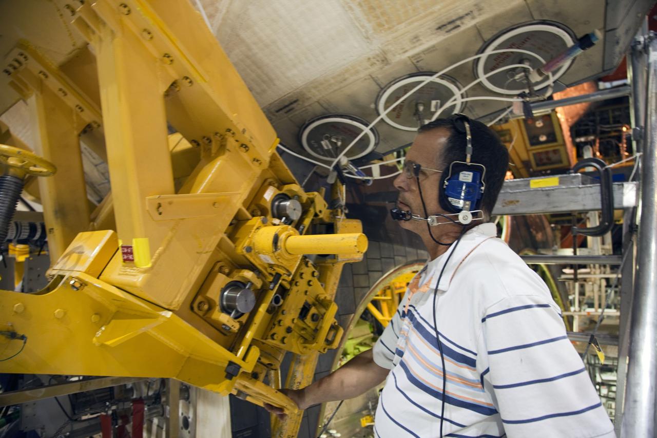 CAPE CANAVERAL, Fla. -- In Orbiter Processing Facility-1 at NASA’s Kennedy Space Center in Florida, a worker monitors the progress as an overhead crane is moved into place around shuttle Endeavour’s left-hand orbital maneuvering system, or OMS, pod, to begin removal of the component. The work is part of Endeavour’s transition and retirement processing. The spacecraft is being prepared for public display at the California Science Center in Los Angeles. Endeavour flew 25 missions, spent 299 days in space, orbited Earth 4,671 times and traveled 122, 883, 151 miles over the course of its 19-year career. Endeavour’s STS-134 and final mission was completed after landing on June 1, 2011. Photo credit: Frank Michaux