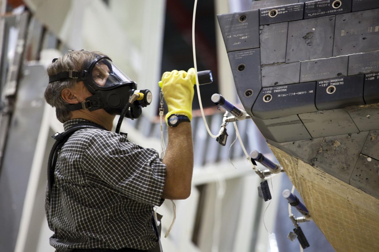 CAPE CANAVERAL, Fla. -- In Orbiter Processing Facility-1 at NASA’s Kennedy Space Center in Florida, a technician wearing safety equipment inspects shuttle Endeavour’s left-hand orbital maneuvering system, or OMS, pod, while the component is removed using a large overhead crane. The work is part of Endeavour’s transition and retirement processing. The spacecraft is being prepared for public display at the California Science Center in Los Angeles. Endeavour flew 25 missions, spent 299 days in space, orbited Earth 4,671 times and traveled 122, 883, 151 miles over the course of its 19-year career. Endeavour’s STS-134 and final mission was completed after landing on June 1, 2011. Photo credit: Frank Michaux