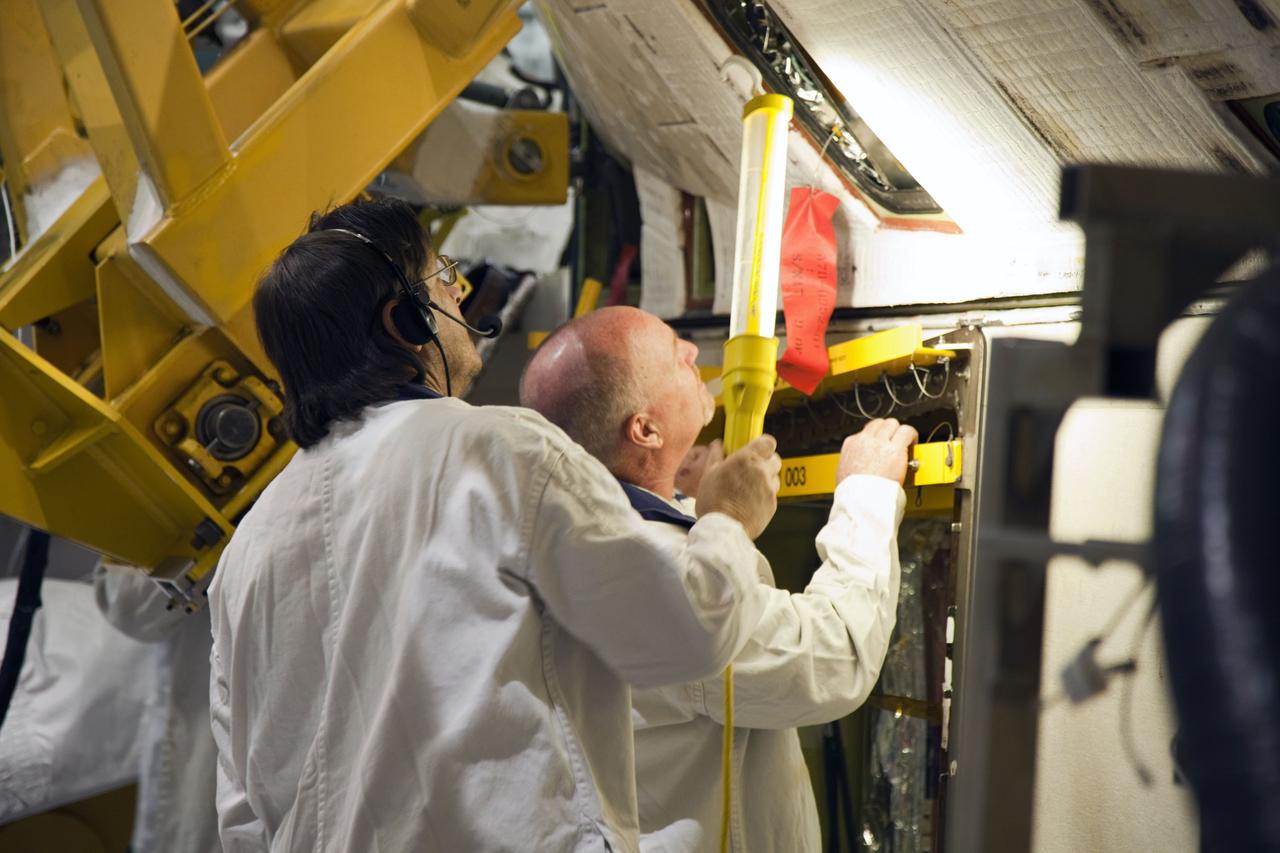 CAPE CANAVERAL, Fla. -- In Orbiter Processing Facility-1 at NASA’s Kennedy Space Center in Florida, technicians monitor the progress as an overhead crane removes shuttle Endeavour’s left-hand orbital maneuvering system, or OMS, pod. The work is part of Endeavour’s transition and retirement processing. The spacecraft is being prepared for public display at the California Science Center in Los Angeles. Endeavour flew 25 missions, spent 299 days in space, orbited Earth 4,671 times and traveled 122, 883, 151 miles over the course of its 19-year career. Endeavour’s STS-134 and final mission was completed after landing on June 1, 2011. Photo credit: Frank Michaux