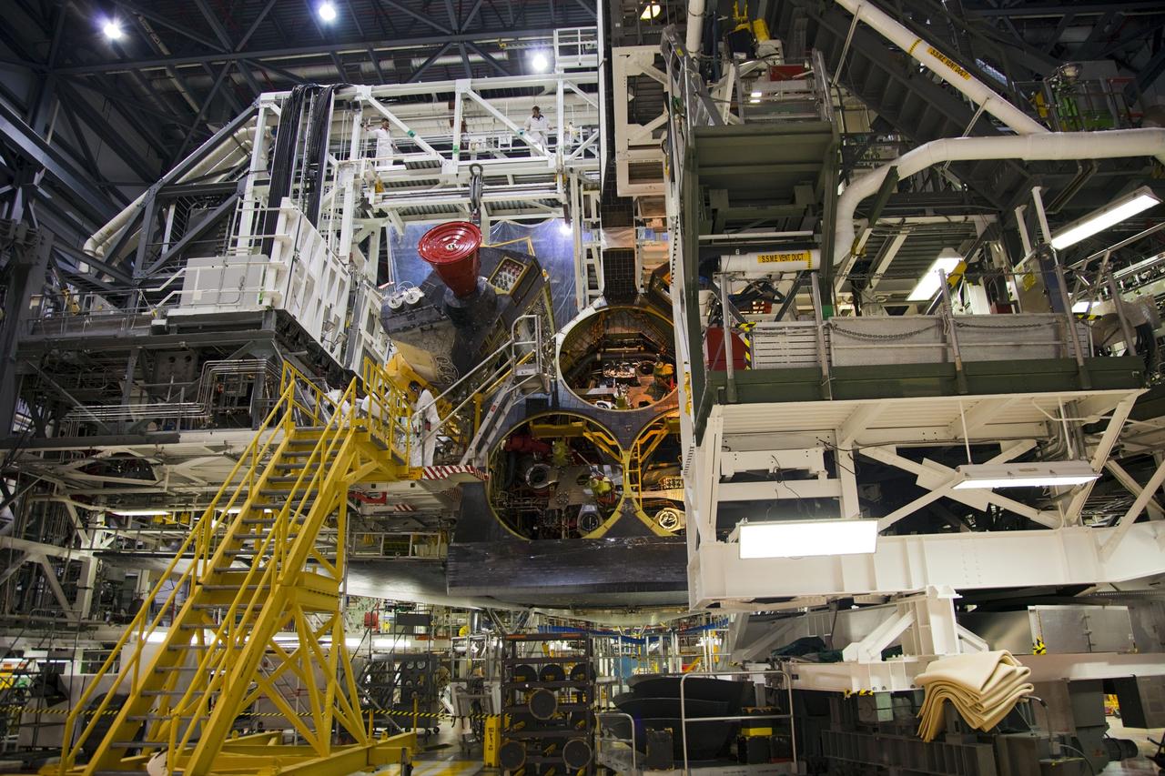 CAPE CANAVERAL, Fla. -- In Orbiter Processing Facility-1 at NASA’s Kennedy Space Center in Florida, a large overhead crane removes shuttle Endeavour’s left-hand orbital maneuvering system, or OMS, pod. The work is part of Endeavour’s transition and retirement processing. The spacecraft is being prepared for public display at the California Science Center in Los Angeles. Endeavour flew 25 missions, spent 299 days in space, orbited Earth 4,671 times and traveled 122, 883, 151 miles over the course of its 19-year career. Endeavour’s STS-134 and final mission was completed after landing on June 1, 2011. Photo credit: Frank Michaux