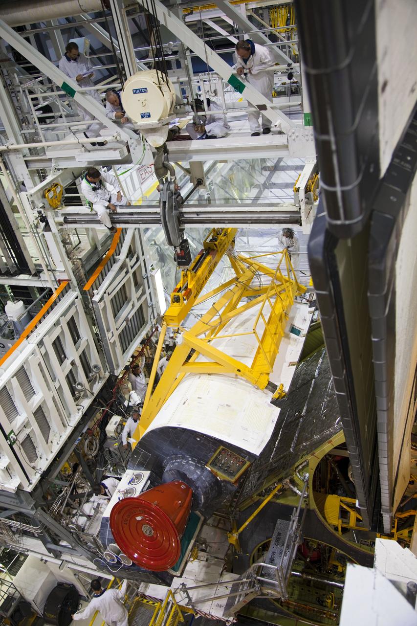 CAPE CANAVERAL, Fla. -- In Orbiter Processing Facility-1 at NASA’s Kennedy Space Center in Florida, an overhead crane is used to remove shuttle Endeavour’s left-hand orbital maneuvering system, or OMS, pod. The work is part of Endeavour’s transition and retirement processing. The spacecraft is being prepared for public display at the California Science Center in Los Angeles. Endeavour flew 25 missions, spent 299 days in space, orbited Earth 4,671 times and traveled 122, 883, 151 miles over the course of its 19-year career. Endeavour’s STS-134 and final mission was completed after landing on June 1, 2011. Photo credit: Frank Michaux