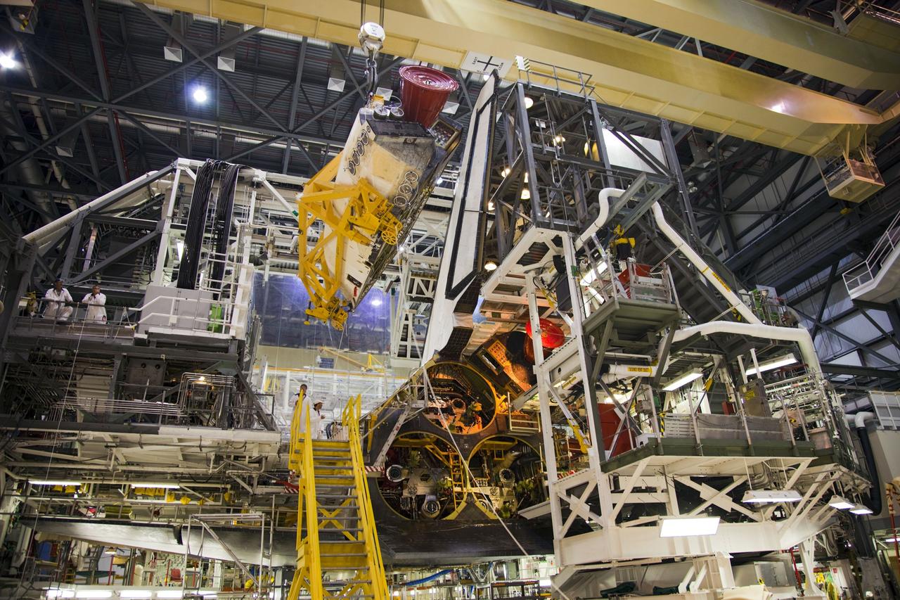 CAPE CANAVERAL, Fla. -- In Orbiter Processing Facility-1 at NASA’s Kennedy Space Center in Florida, an overhead crane is used to remove shuttle Endeavour’s left-hand orbital maneuvering system, or OMS, pod. The work is part of Endeavour’s transition and retirement processing. The spacecraft is being prepared for public display at the California Science Center in Los Angeles. Endeavour flew 25 missions, spent 299 days in space, orbited Earth 4,671 times and traveled 122, 883, 151 miles over the course of its 19-year career. Endeavour’s STS-134 and final mission was completed after landing on June 1, 2011. Photo credit: Frank Michaux