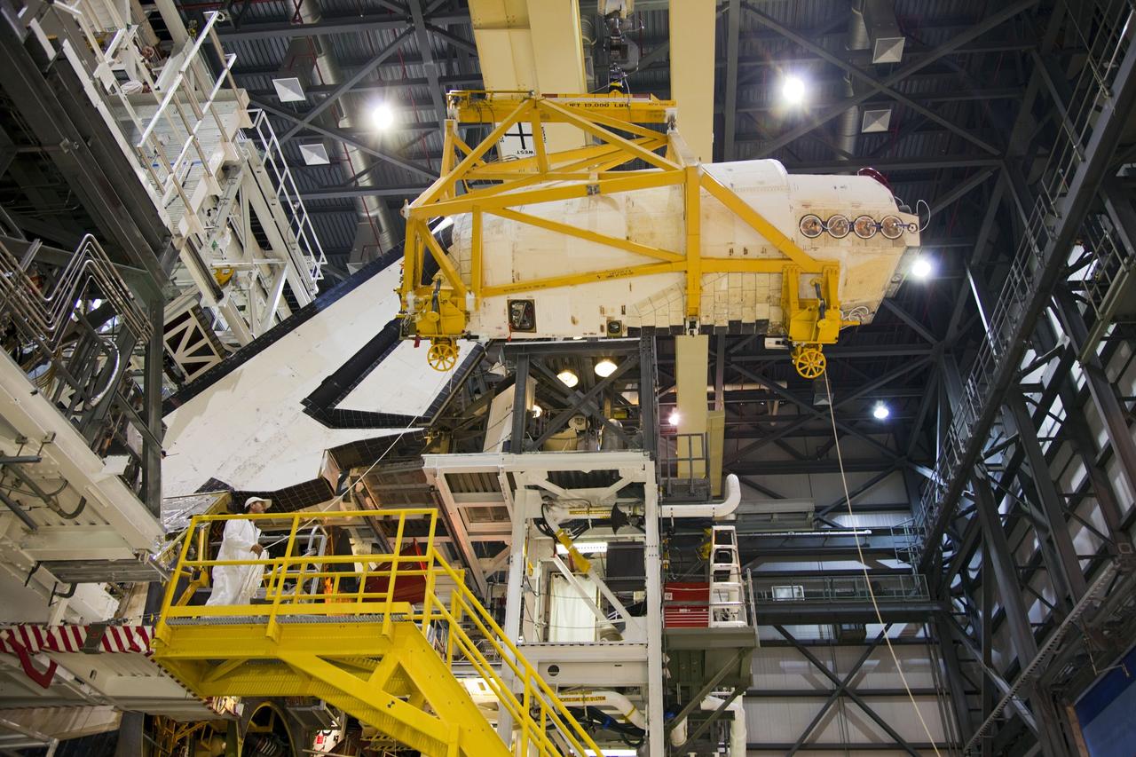 CAPE CANAVERAL, Fla. -- In Orbiter Processing Facility-1 at NASA’s Kennedy Space Center in Florida, an overhead crane moves shuttle Endeavour’s left-hand orbital maneuvering system, or OMS, pod away from the spacecraft. The work is part of Endeavour’s transition and retirement processing. The spacecraft is being prepared for public display at the California Science Center in Los Angeles. Endeavour flew 25 missions, spent 299 days in space, orbited Earth 4,671 times and traveled 122, 883, 151 miles over the course of its 19-year career. Endeavour’s STS-134 and final mission was completed after landing on June 1, 2011. Photo credit: Frank Michaux
