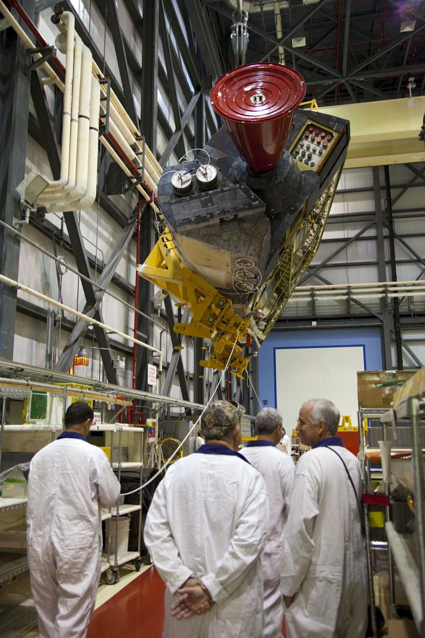 CAPE CANAVERAL, Fla. -- In Orbiter Processing Facility-1 at NASA’s Kennedy Space Center in Florida, technicians monitor the progress as an overhead crane moves shuttle Endeavour’s left-hand orbital maneuvering system, or OMS, pod toward a transporter. It will then be moved to the Hypergol Maintenance Facility. The work is part of Endeavour’s transition and retirement processing. The spacecraft is being prepared for public display at the California Science Center in Los Angeles. Endeavour flew 25 missions, spent 299 days in space, orbited Earth 4,671 times and traveled 122, 883, 151 miles over the course of its 19-year career. Endeavour’s STS-134 and final mission was completed after landing on June 1, 2011. Photo credit: Frank Michaux