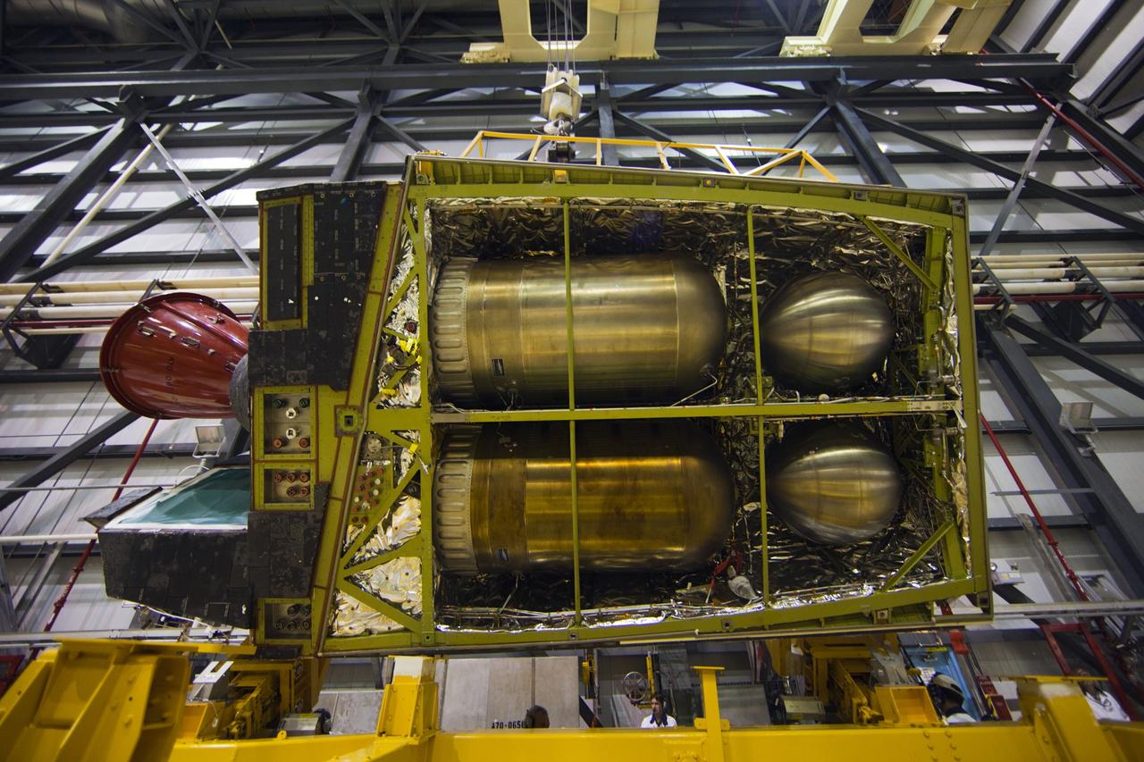 CAPE CANAVERAL, Fla. -- In Orbiter Processing Facility-1 at NASA’s Kennedy Space Center in Florida, a rare underside view of shuttle Endeavour’s left-hand orbital maneuvering system, or OMS, pod can be seen as an overhead crane lowers the component onto a transporter. It will then be moved to the Hypergol Maintenance Facility. The work is part of Endeavour’s transition and retirement processing. The spacecraft is being prepared for public display at the California Science Center in Los Angeles. Endeavour flew 25 missions, spent 299 days in space, orbited Earth 4,671 times and traveled 122, 883, 151 miles over the course of its 19-year career. Endeavour’s STS-134 and final mission was completed after landing on June 1, 2011. Photo credit: Frank Michaux