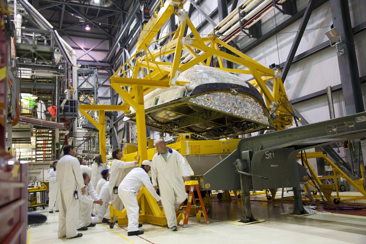 CAPE CANAVERAL, Fla. -- In Orbiter Processing Facility-1 at NASA’s Kennedy Space Center in Florida, technicians assist as an overhead crane lowers shuttle Endeavour’s left-hand orbital maneuvering system, or OMS, pod onto a transporter. It will then be moved to the Hypergol Maintenance Facility. The work is part of Endeavour’s transition and retirement processing. The spacecraft is being prepared for public display at the California Science Center in Los Angeles. Endeavour flew 25 missions, spent 299 days in space, orbited Earth 4,671 times and traveled 122, 883, 151 miles over the course of its 19-year career. Endeavour’s STS-134 and final mission was completed after landing on June 1, 2011. Photo credit: Frank Michaux