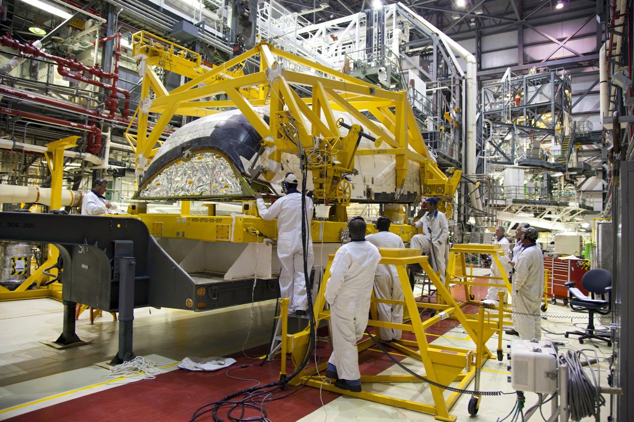 CAPE CANAVERAL, Fla. -- In Orbiter Processing Facility-1 at NASA’s Kennedy Space Center in Florida, technicians secure shuttle Endeavour’s left-hand orbital maneuvering system, or OMS, pod onto a transporter. It will then be moved to the Hypergol Maintenance Facility. The work is part of Endeavour’s transition and retirement processing. The spacecraft is being prepared for public display at the California Science Center in Los Angeles. Endeavour flew 25 missions, spent 299 days in space, orbited Earth 4,671 times and traveled 122, 883, 151 miles over the course of its 19-year career. Endeavour’s STS-134 and final mission was completed after landing on June 1, 2011. Photo credit: Frank Michaux