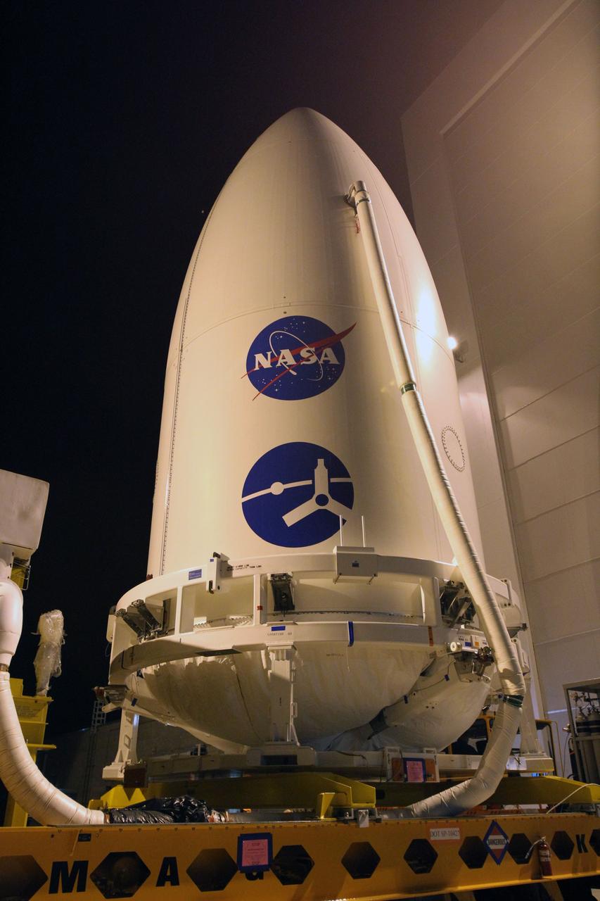 CAPE CANAVERAL, Fla. -- The door to the high bay of the Astrotech Space Operations' payload processing facility in Titusville, Fla., closes behind the Juno spacecraft, enclosed in an Atlas payload fairing, as its trip to Space Launch Complex 41 begins.    The fairing will protect the spacecraft from the impact of aerodynamic pressure and heating during ascent and will be jettisoned once the spacecraft is outside the Earth's atmosphere. Juno is scheduled to launch Aug. 5 aboard a United Launch Alliance Atlas V rocket from Cape Canaveral Air Force Station in Florida. The solar-powered spacecraft will orbit Jupiter's poles 33 times to find out more about the gas giant's origins, structure, atmosphere and magnetosphere and investigate the existence of a solid planetary core. For more information, visit www.nasa.gov/juno. Photo credit: NASA/Cory Huston