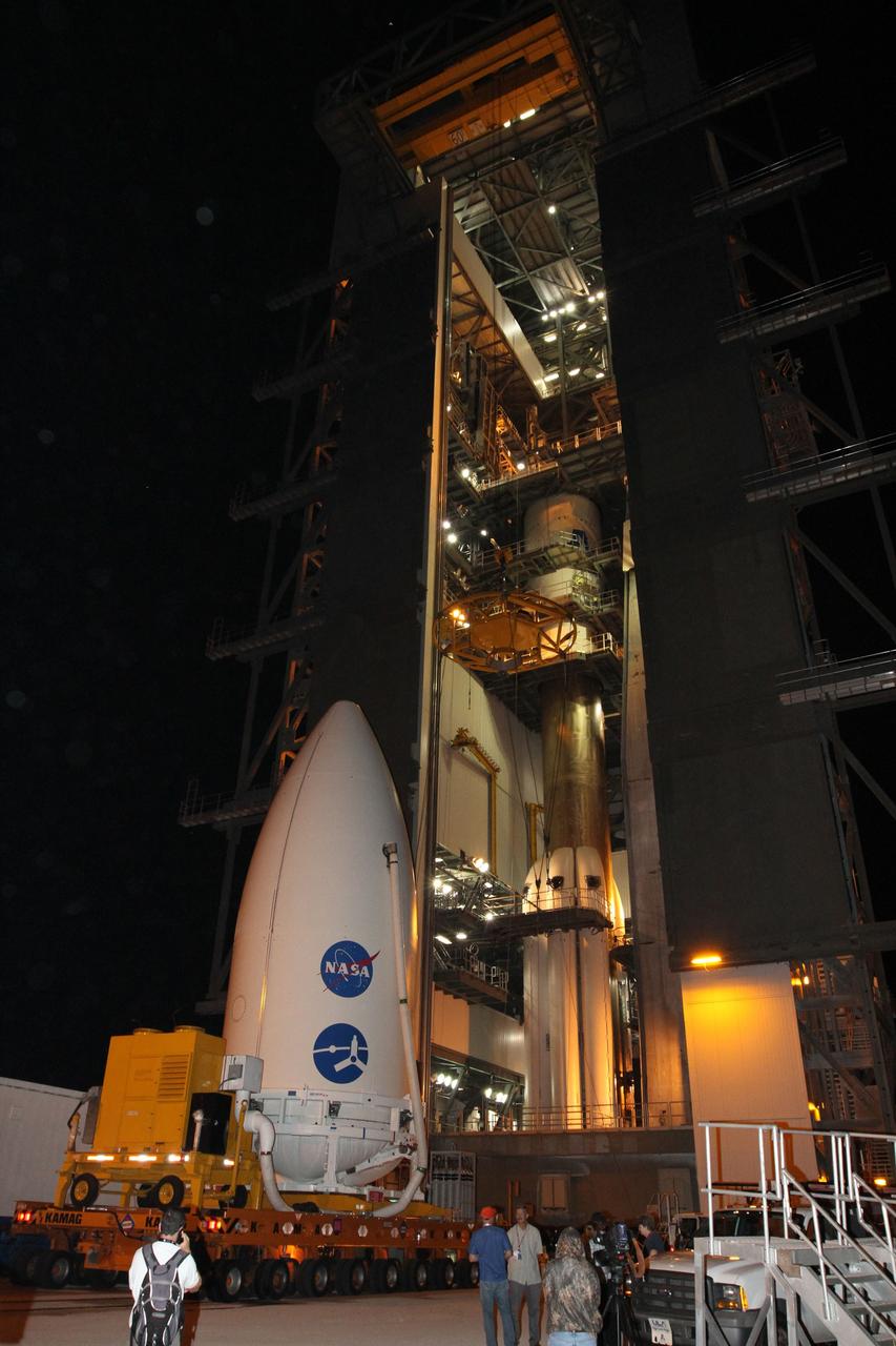 CAPE CANAVERAL, Fla. -- The Juno spacecraft, enclosed in an Atlas payload fairing, arrives at Space Launch Complex 41. The spacecraft was prepared for launch in the Astrotech Space Operations' payload processing facility in Titusville, Fla.    The fairing will protect the spacecraft from the impact of aerodynamic pressure and heating during ascent and will be jettisoned once the spacecraft is outside the Earth's atmosphere. Juno is scheduled to launch Aug. 5 aboard a United Launch Alliance Atlas V rocket from Cape Canaveral Air Force Station in Florida. The solar-powered spacecraft will orbit Jupiter's poles 33 times to find out more about the gas giant's origins, structure, atmosphere and magnetosphere and investigate the existence of a solid planetary core. For more information, visit www.nasa.gov/juno. Photo credit: NASA/Cory Huston