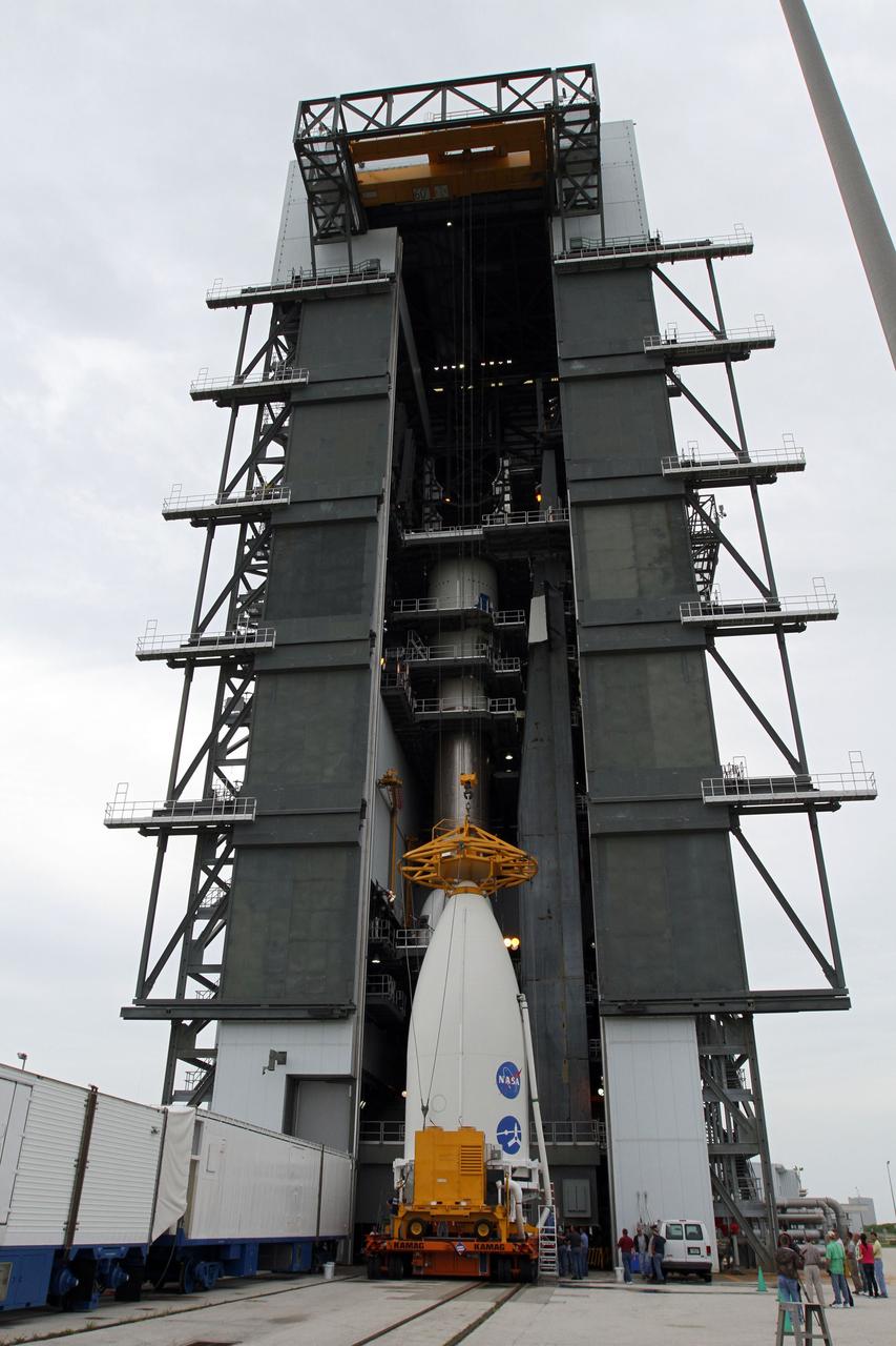 CAPE CANAVERAL, Fla. -- At Space Launch Complex 41, a crane is attached to the nose of the Atlas payload fairing enclosing the Juno spacecraft in preparation for its lift to the top of the Atlas rocket stacked in the Vertical Integration Facility.  The spacecraft was prepared for launch in the Astrotech Space Operations' payload processing facility in Titusville, Fla.    The fairing will protect the spacecraft from the impact of aerodynamic pressure and heating during ascent and will be jettisoned once the spacecraft is outside the Earth's atmosphere. Juno is scheduled to launch Aug. 5 aboard a United Launch Alliance Atlas V rocket from Cape Canaveral Air Force Station in Florida. The solar-powered spacecraft will orbit Jupiter's poles 33 times to find out more about the gas giant's origins, structure, atmosphere and magnetosphere and investigate the existence of a solid planetary core. For more information, visit www.nasa.gov/juno. Photo credit: NASA/Cory Huston