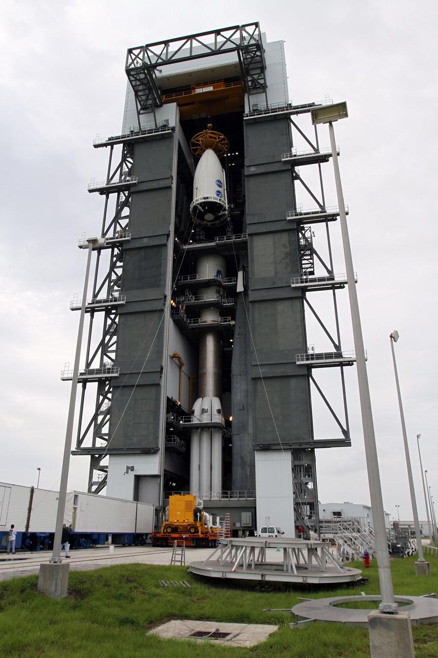 CAPE CANAVERAL, Fla. -- At Space Launch Complex 41, the Atlas rocket stacked inside the Vertical Integration Facility stands ready to receive the Juno spacecraft, enclosed in an Atlas payload fairing.  The spacecraft was prepared for launch in the Astrotech Space Operations' payload processing facility in Titusville, Fla.    The fairing will protect the spacecraft from the impact of aerodynamic pressure and heating during ascent and will be jettisoned once the spacecraft is outside the Earth's atmosphere. Juno is scheduled to launch Aug. 5 aboard a United Launch Alliance Atlas V rocket from Cape Canaveral Air Force Station in Florida. The solar-powered spacecraft will orbit Jupiter's poles 33 times to find out more about the gas giant's origins, structure, atmosphere and magnetosphere and investigate the existence of a solid planetary core. For more information, visit www.nasa.gov/juno. Photo credit: NASA/Cory Huston