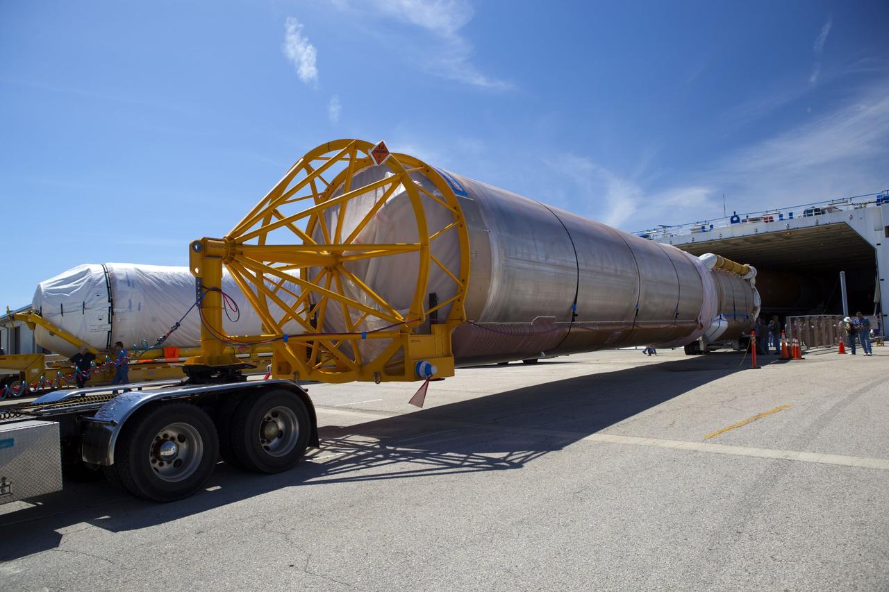 CAPE CANAVERAL, Fla. -- The Atlas V first stage (right) and Centaur upper stage to support the Mars Science Laboratory (MSL) mission are offloaded from the Delta Mariner transport ship at Port Canaveral in Florida.    MSL's components include a compact car-sized rover, Curiosity, which has 10 science instruments designed to search for evidence on whether Mars has had environments favorable to microbial life, including chemical ingredients for life.  The unique rover will use a laser to look inside rocks and release its gasses so that the rover’s spectrometer can analyze and send the data back to Earth. Launch of MSL aboard a United Launch Alliance Atlas V rocket is scheduled for Nov. 25 from Space Launch Complex 41 on Cape Canaveral Air Force Station. For more information, visit http://www.nasa.gov/msl. Photo credit: NASA/Dimitri Gerondidakis