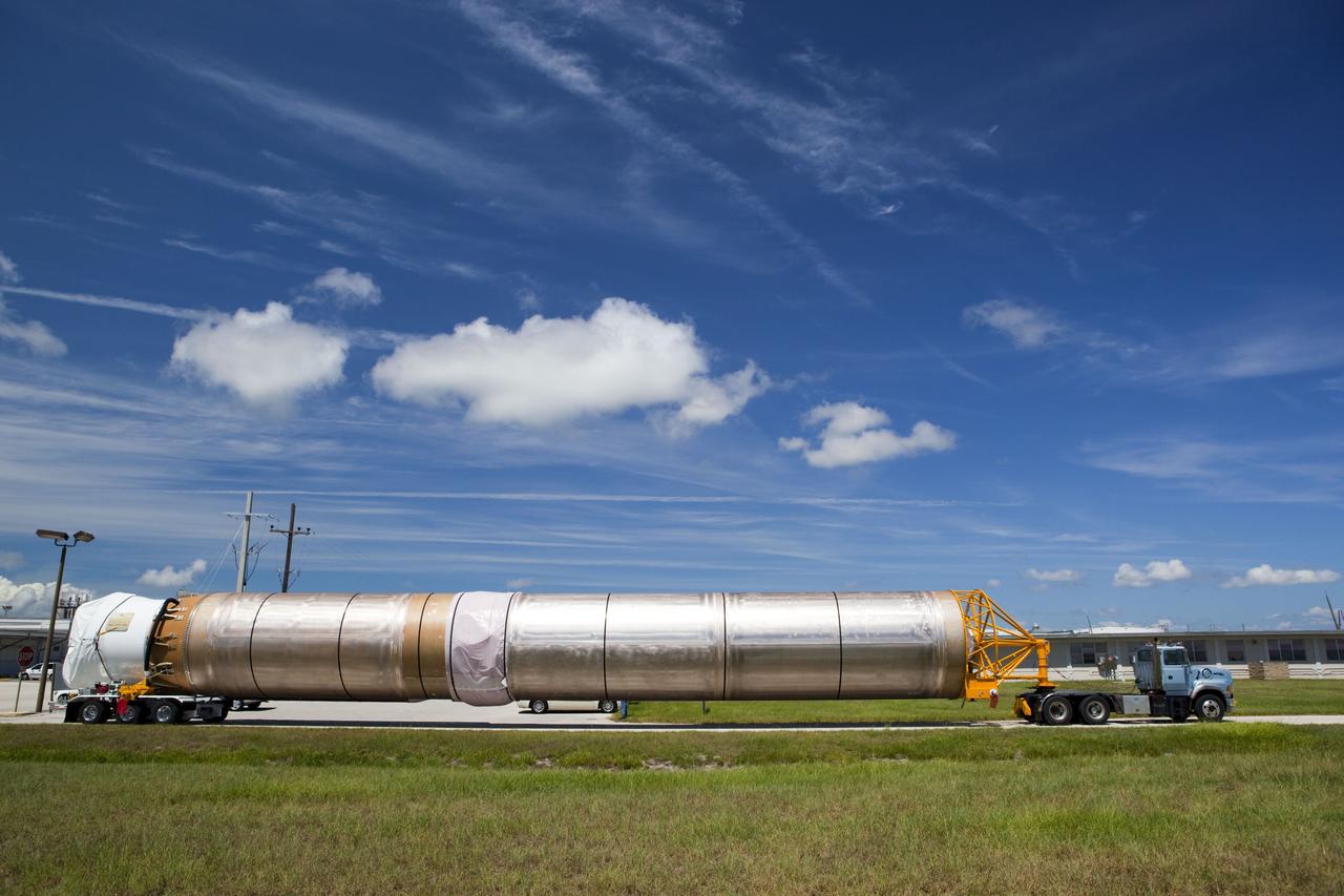 CAPE CANAVERAL, Fla. -- The Atlas V first stage to support the Mars Science Laboratory (MSL) mission begins its trip from Port Canaveral to the Atlas Spaceflight Operations Center on Cape Canaveral Air Force Station in Florida.    MSL's components include a compact car-sized rover, Curiosity, which has 10 science instruments designed to search for evidence on whether Mars has had environments favorable to microbial life, including chemical ingredients for life.  The unique rover will use a laser to look inside rocks and release its gasses so that the rover’s spectrometer can analyze and send the data back to Earth. Launch of MSL aboard a United Launch Alliance Atlas V rocket is scheduled for Nov. 25 from Space Launch Complex 41 on Cape Canaveral Air Force Station. For more information, visit http://www.nasa.gov/msl. Photo credit: NASA/Dimitri Gerondidakis