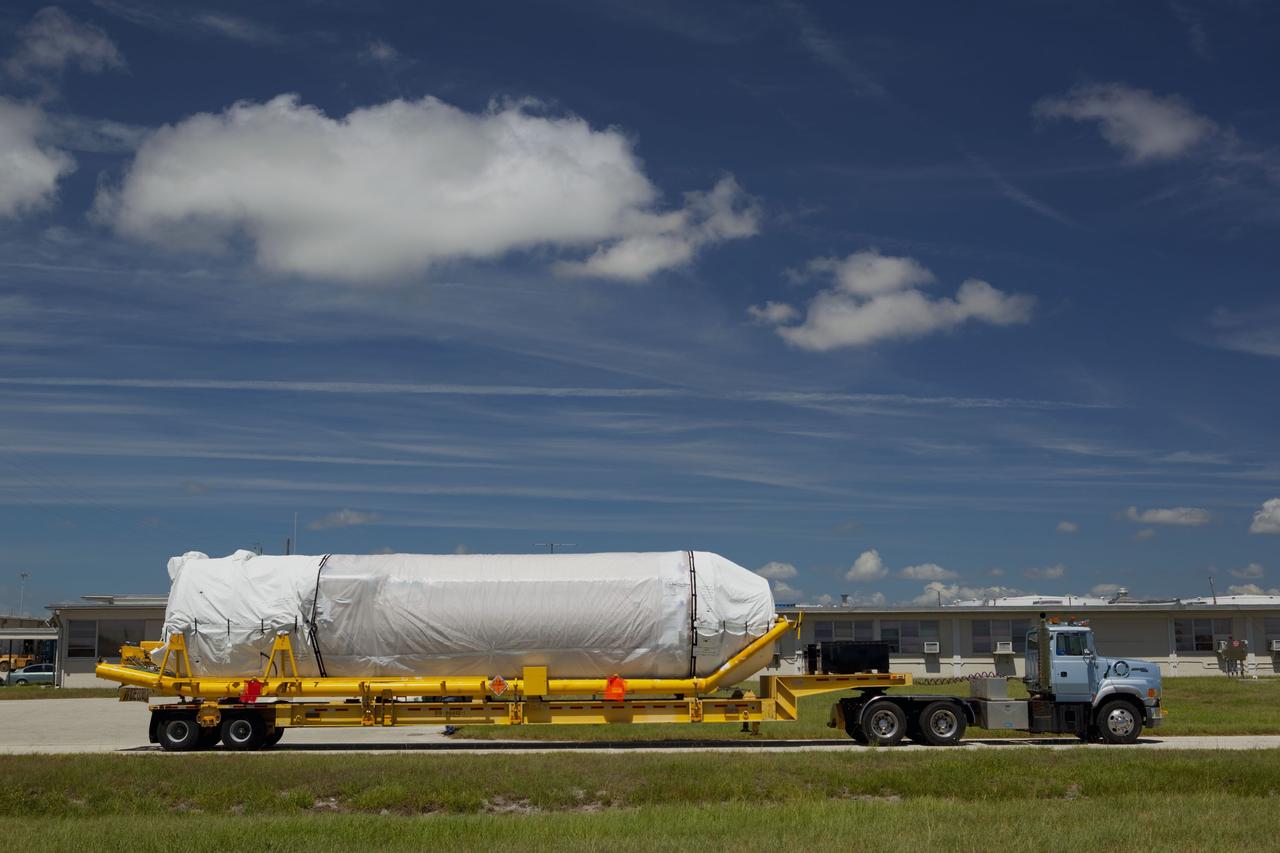 CAPE CANAVERAL, Fla. -- The Centaur upper stage to support the Mars Science Laboratory (MSL) mission begins its trip from Port Canaveral to the Atlas Spaceflight Operations Center on Cape Canaveral Air Force Station in Florida.    MSL's components include a compact car-sized rover, Curiosity, which has 10 science instruments designed to search for evidence on whether Mars has had environments favorable to microbial life, including chemical ingredients for life.  The unique rover will use a laser to look inside rocks and release its gasses so that the rover’s spectrometer can analyze and send the data back to Earth. Launch of MSL aboard a United Launch Alliance Atlas V rocket is scheduled for Nov. 25 from Space Launch Complex 41 on Cape Canaveral Air Force Station. For more information, visit http://www.nasa.gov/msl. Photo credit: NASA/Dimitri Gerondidakis