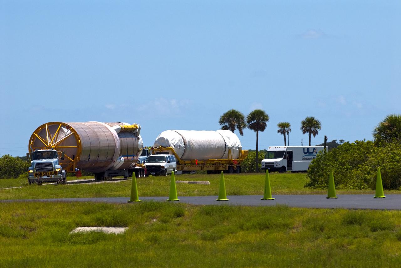 CAPE CANAVERAL, Fla. -- The Atlas V first stage (left) and Centaur upper stage to support the Mars Science Laboratory (MSL) mission approach the Atlas Spaceflight Operations Center on Cape Canaveral Air Force Station in Florida.    MSL's components include a compact car-sized rover, Curiosity, which has 10 science instruments designed to search for evidence on whether Mars has had environments favorable to microbial life, including chemical ingredients for life.  The unique rover will use a laser to look inside rocks and release its gasses so that the rover’s spectrometer can analyze and send the data back to Earth. Launch of MSL aboard a United Launch Alliance Atlas V rocket is scheduled for Nov. 25 from Space Launch Complex 41 on Cape Canaveral Air Force Station. For more information, visit http://www.nasa.gov/msl. Photo credit: NASA/Kim Shiflett