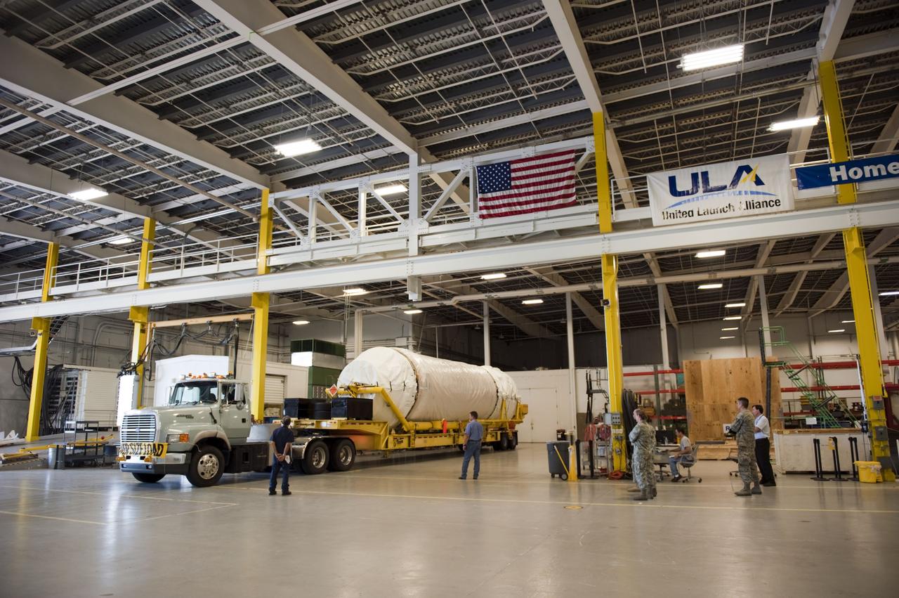 CAPE CANAVERAL, Fla. -- The Centaur upper stage to support the Mars Science Laboratory (MSL) mission is delivered into the Atlas Spaceflight Operations Center on Cape Canaveral Air Force Station in Florida.    MSL's components include a compact car-sized rover, Curiosity, which has 10 science instruments designed to search for evidence on whether Mars has had environments favorable to microbial life, including chemical ingredients for life.  The unique rover will use a laser to look inside rocks and release its gasses so that the rover’s spectrometer can analyze and send the data back to Earth. Launch of MSL aboard a United Launch Alliance Atlas V rocket is scheduled for Nov. 25 from Space Launch Complex 41 on Cape Canaveral Air Force Station. For more information, visit http://www.nasa.gov/msl. Photo credit: NASA/Kim Shiflett