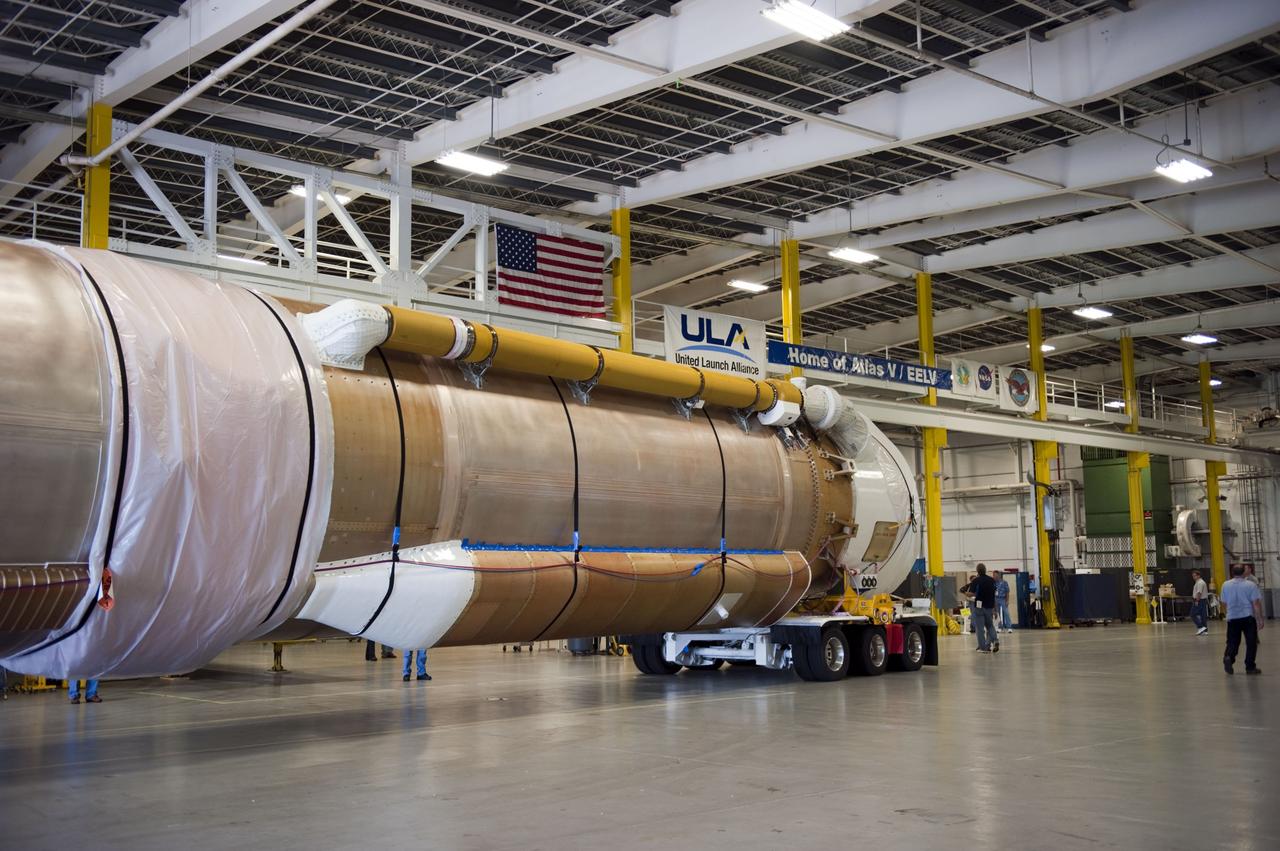 CAPE CANAVERAL, Fla. -- The Atlas V first stage to support the Mars Science Laboratory (MSL) mission rolls into position in the Atlas Spaceflight Operations Center on Cape Canaveral Air Force Station in Florida.    MSL's components include a compact car-sized rover, Curiosity, which has 10 science instruments designed to search for evidence on whether Mars has had environments favorable to microbial life, including chemical ingredients for life.  The unique rover will use a laser to look inside rocks and release its gasses so that the rover’s spectrometer can analyze and send the data back to Earth. Launch of MSL aboard a United Launch Alliance Atlas V rocket is scheduled for Nov. 25 from Space Launch Complex 41 on Cape Canaveral Air Force Station. For more information, visit http://www.nasa.gov/msl. Photo credit: NASA/Kim Shiflett