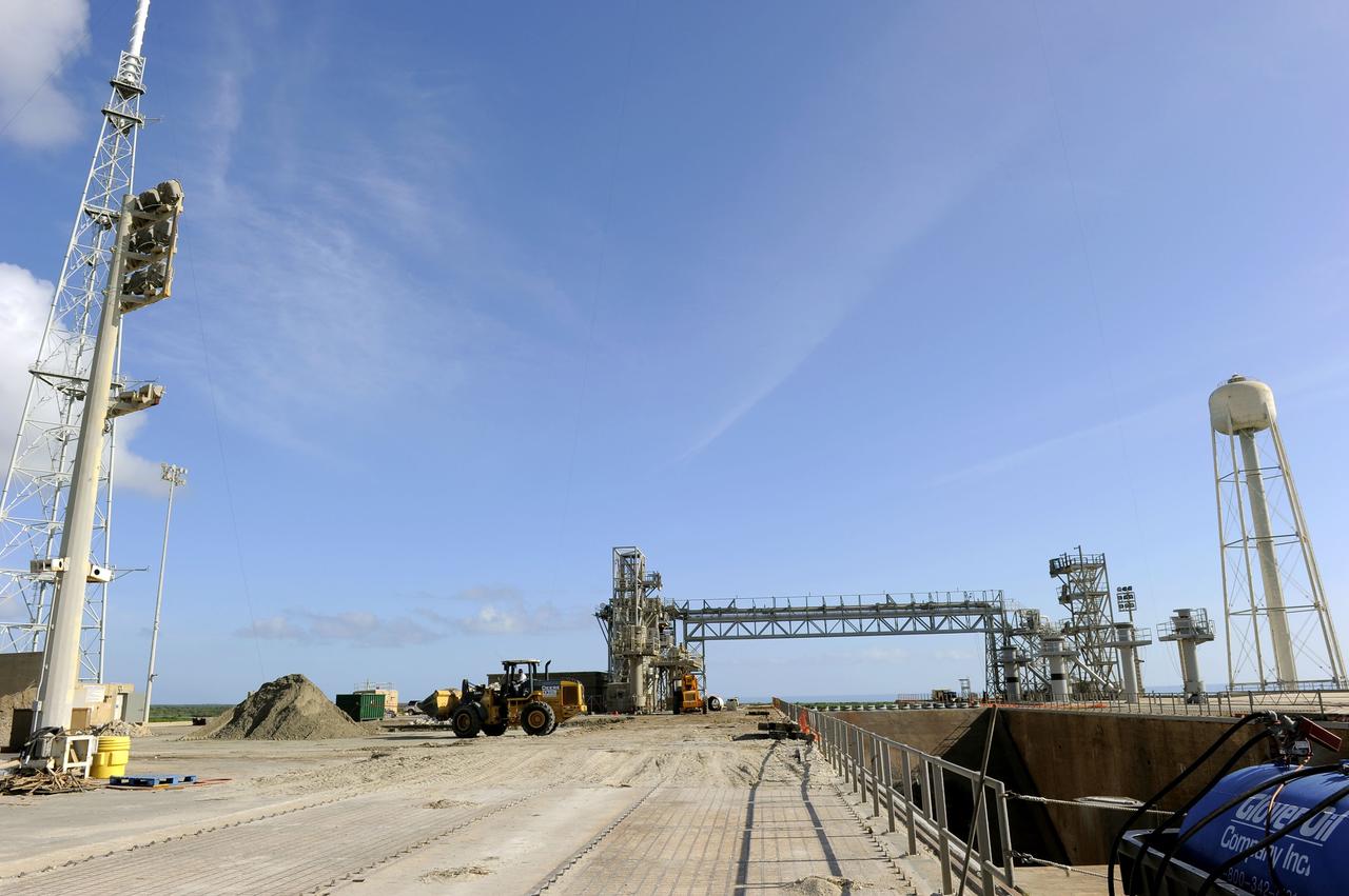 CAPE CANAVERAL, Fla. -- At NASA's Kennedy Space Center in Florida, a bulldozer is enlisted in the cleanup of Launch Pad 39B. Sand, reinforcing steel and large wooden mats were placed over the pad's concrete surfaces during deconstruction to protect them from falling debris. In 2009, the structure at the pad was no longer needed for NASA's Space Shuttle Program, so it is being restructured for future use. The new design will feature a "clean pad" for rockets to come with their own launcher, making it more versatile for a number of rockets and spacecraft. The lightning protection system, consisting of three lightning towers and a wire catenary system, will remain. For information on NASA's future plans, visit http://www.nasa.gov/exploration. Photo credit: NASA/Kim Shiflett