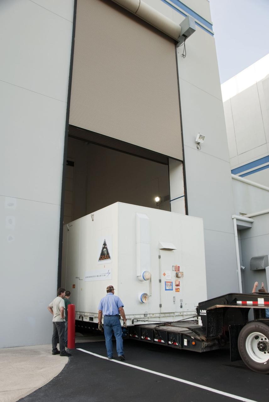 CAPE CANAVERAL, Fla. -- The protective canister housing NASA's twin Gravity Recovery and Interior Laboratory lunar spacecraft arrives at the Hazardous Processing Facility (HPF) at Astrotech Space Operation's payload processing facility in Titusville, Fla. In the HPF, the spacecraft will undergo two days of fueling activities. GRAIL will fly in tandem orbits around the moon for several months to measure its gravity field. GRAIL's primary science objectives are to determine the structure of the lunar interior, from crust to core, and to advance understanding of the thermal evolution of the moon. Launch aboard a United Launch Alliance Delta II rocket from Space Launch Complex 17B on Cape Canaveral Air Force Station is scheduled for Sept. 8. For more information, visit http://www.nasa.gov/grail. Photo credit: NASA/Charisse Nahser