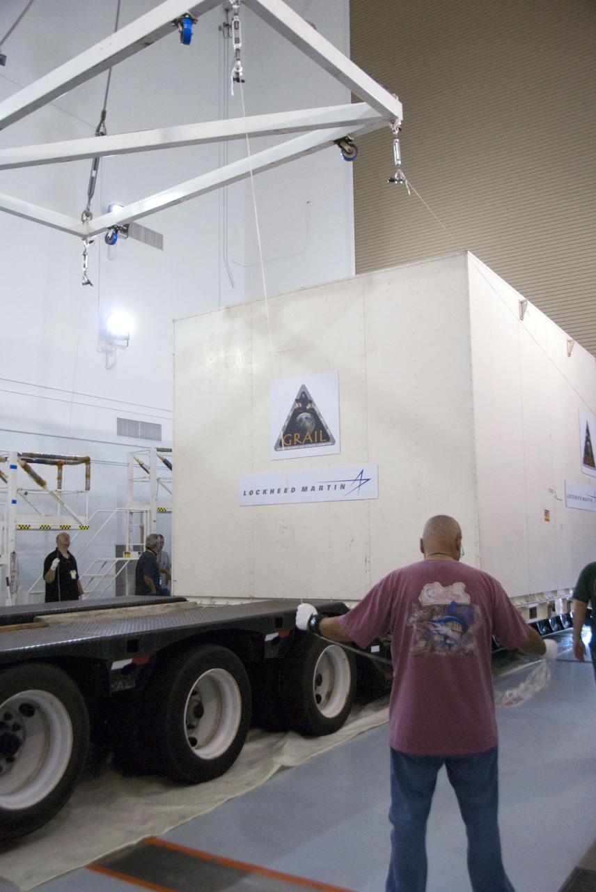 CAPE CANAVERAL, Fla. -- Lockheed Martin technicians oversee the lift of the protective canister housing NASA's twin Gravity Recovery and Interior Laboratory lunar spacecraft from the transporter in the Hazardous Processing Facility (HPF) at Astrotech Space Operation's payload processing facility in Titusville, Fla.  In the HPF, the spacecraft will undergo two days of fueling activities.    GRAIL will fly in tandem orbits around the moon for several months to measure its gravity field. GRAIL's primary science objectives are to determine the structure of the lunar interior, from crust to core, and to advance understanding of the thermal evolution of the moon.  Launch aboard a United Launch Alliance Delta II rocket from Space Launch Complex 17B on Cape Canaveral Air Force Station is scheduled for Sept. 8.  For more information, visit http://www.nasa.gov/grail. Photo credit: NASA/Charisse Nahser