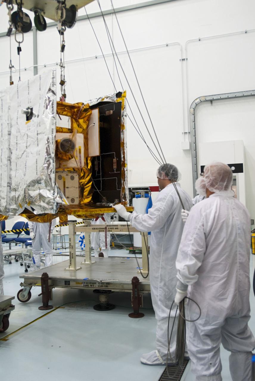 CAPE CANAVERAL, Fla. -- Lockheed Martin technicians move one of NASA's twin Gravity Recovery and Interior Laboratory lunar spacecraft toward a workstand in the Hazardous Processing Facility (HPF) at Astrotech Space Operation's payload processing facility in Titusville, Fla.  In the HPF, the spacecraft will undergo two days of fueling activities.    GRAIL will fly in tandem orbits around the moon for several months to measure its gravity field. GRAIL's primary science objectives are to determine the structure of the lunar interior, from crust to core, and to advance understanding of the thermal evolution of the moon.  Launch aboard a United Launch Alliance Delta II rocket from Space Launch Complex 17B on Cape Canaveral Air Force Station is scheduled for Sept. 8.  For more information, visit http://www.nasa.gov/grail. Photo credit: NASA/Charisse Nahser