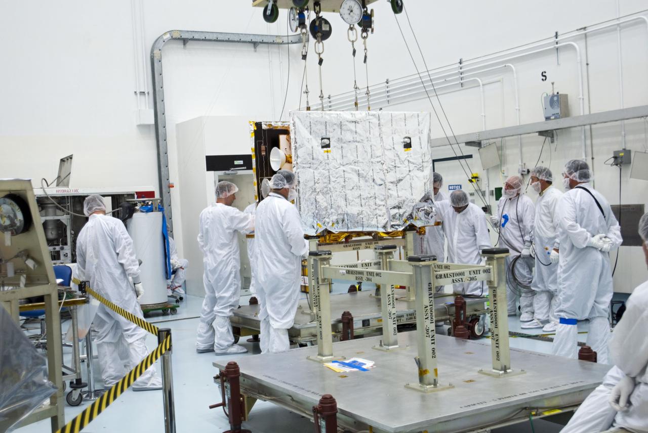 CAPE CANAVERAL, Fla. -- Lockheed Martin technicians lower one of NASA's twin Gravity Recovery and Interior Laboratory lunar spacecraft onto a workstand in the Hazardous Processing Facility (HPF) at Astrotech Space Operation's payload processing facility in Titusville, Fla.  In the HPF, the spacecraft will undergo two days of fueling activities.    GRAIL will fly in tandem orbits around the moon for several months to measure its gravity field. GRAIL's primary science objectives are to determine the structure of the lunar interior, from crust to core, and to advance understanding of the thermal evolution of the moon.  Launch aboard a United Launch Alliance Delta II rocket from Space Launch Complex 17B on Cape Canaveral Air Force Station is scheduled for Sept. 8.  For more information, visit http://www.nasa.gov/grail. Photo credit: NASA/Charisse Nahser