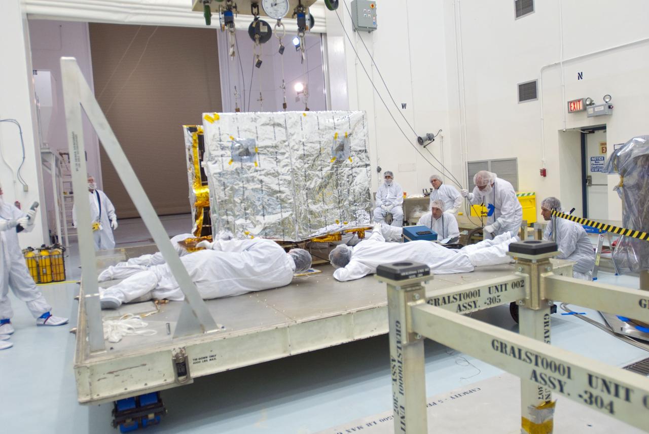 CAPE CANAVERAL, Fla. -- Lockheed Martin technicians inspect the second of NASA's twin Gravity Recovery and Interior Laboratory lunar spacecraft as they prepare to move it to a workstand in the Hazardous Processing Facility (HPF) at Astrotech Space Operation's payload processing facility in Titusville, Fla.  In the HPF, the spacecraft will undergo two days of fueling activities.    GRAIL will fly in tandem orbits around the moon for several months to measure its gravity field. GRAIL's primary science objectives are to determine the structure of the lunar interior, from crust to core, and to advance understanding of the thermal evolution of the moon.  Launch aboard a United Launch Alliance Delta II rocket from Space Launch Complex 17B on Cape Canaveral Air Force Station is scheduled for Sept. 8.  For more information, visit http://www.nasa.gov/grail. Photo credit: NASA/Charisse Nahser