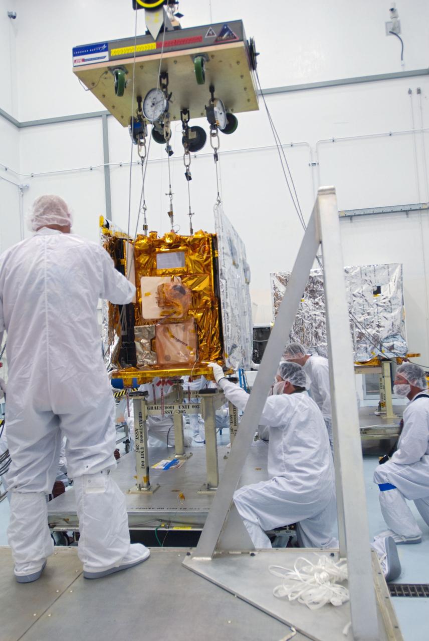 CAPE CANAVERAL, Fla. -- Lockheed Martin technicians lower the second of NASA's twin Gravity Recovery and Interior Laboratory lunar spacecraft onto a workstand in the Hazardous Processing Facility (HPF) at Astrotech Space Operation's payload processing facility in Titusville, Fla. In the HPF, the spacecraft will undergo two days of fueling activities. GRAIL will fly in tandem orbits around the moon for several months to measure its gravity field. GRAIL's primary science objectives are to determine the structure of the lunar interior, from crust to core, and to advance understanding of the thermal evolution of the moon. Launch aboard a United Launch Alliance Delta II rocket from Space Launch Complex 17B on Cape Canaveral Air Force Station is scheduled for Sept. 8. For more information, visit http://www.nasa.gov/grail. Photo credit: NASA/Charisse Nahser
