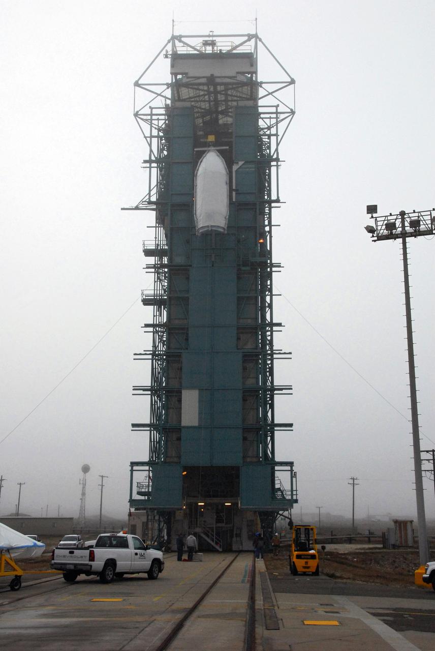 VANDENBERG AIR FORCE BASE, Calif. -- A United Launch Alliance Delta II stands tall on Space Launch Complex-2 at Vandenberg Air Force Base in California for the launch of NASA's National Polar-orbiting Operational Environmental Satellite System Preparatory Project (NPP) satellite. Next up for the rocket configuration is the lifting to Level 5 of the payload fairing that will protect NPP as it launches. NPP will be positioned 512 miles above the Earth's surface and will orbit about 16 times each day to observe nearly the entire globe. The NPP mission for NASA and the National Oceanic and Atmospheric Administration (NOAA) is to measure Earth's atmospheric and sea surface temperatures, humidity sounding, land and ocean biological activity, and cloud and aerosol properties. For more information, visit www.nasa.gov/NPP. Photo credit: NASA/VAFB, Roy Allison