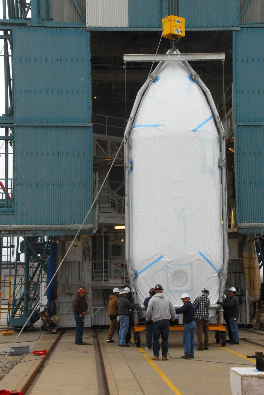 VANDENBERG AIR FORCE BASE, Calif. -- The payload fairing that will protect NASA's National Polar-orbiting Operational Environmental Satellite System Preparatory Project (NPP) satellite as it launches aboard a United Launch Alliance Delta II begins its lift to Level 5 of Space Launch Complex-2 at Vandenberg Air Force Base in California. NPP will be positioned 512 miles above the Earth's surface and will orbit about 16 times each day to observe nearly the entire globe. The NPP mission for NASA and the National Oceanic and Atmospheric Administration (NOAA) is to measure Earth's atmospheric and sea surface temperatures, humidity sounding, land and ocean biological activity, and cloud and aerosol properties. For more information, visit www.nasa.gov/NPP. Photo credit: NASA/VAFB, Roy Allison