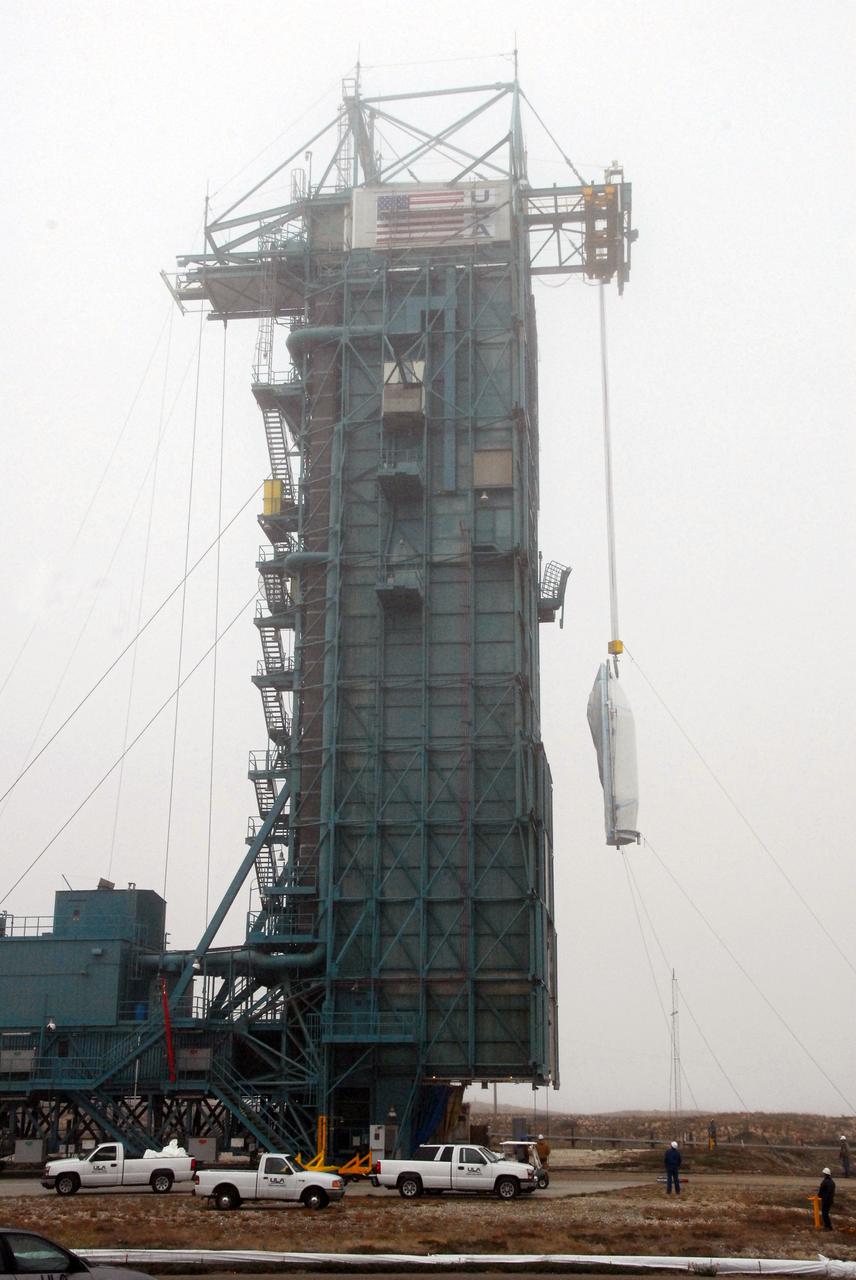 VANDENBERG AIR FORCE BASE, Calif. -- The payload fairing that will protect NASA's National Polar-orbiting Operational Environmental Satellite System Preparatory Project (NPP) satellite as it launches aboard a United Launch Alliance Delta II is lifted to Level 5 of Space Launch Complex-2 at Vandenberg Air Force Base in California.    NPP will be positioned 512 miles above the Earth's surface and will orbit about 16 times each day to observe nearly the entire globe. The NPP mission for NASA and the National Oceanic and Atmospheric Administration (NOAA) is to measure Earth's atmospheric and sea surface temperatures, humidity sounding, land and ocean biological activity, and cloud and aerosol properties. For more information, visit www.nasa.gov/NPP. Photo credit: NASA/VAFB, Roy Allison