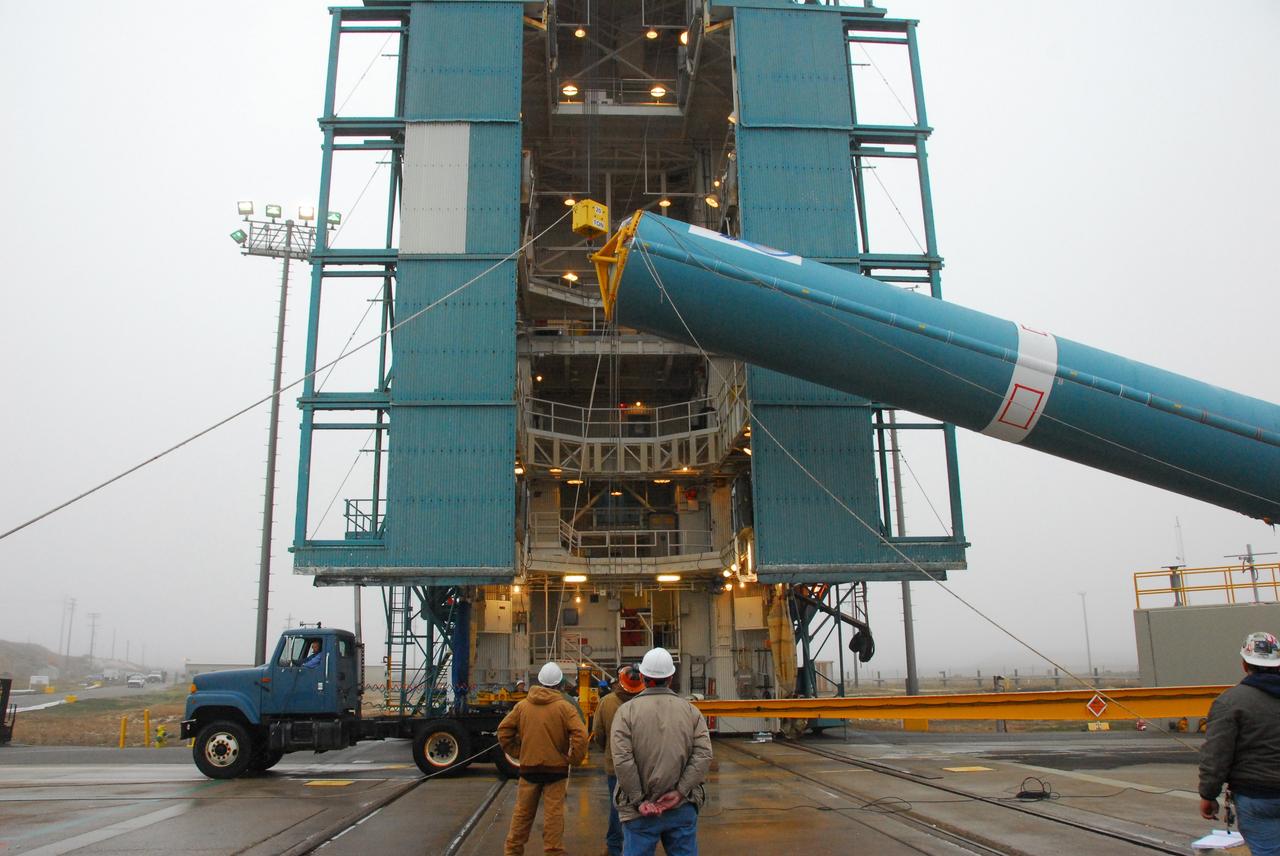VANDENBERG AIR FORCE BASE, Calif. -- The first stage of a United Launch Alliance Delta II is lifted at NASA's Space Launch Complex-2 on Vandenberg Air Force Base in California. The rocket will carry NASA's National Polar-orbiting Operational Environmental Satellite System Preparatory Project (NPP) satellite into space.    NPP will be positioned 512 miles above the Earth's surface and will orbit about 16 times each day to observe nearly the entire globe. The NPP mission for NASA and the National Oceanic and Atmospheric Administration (NOAA) is to measure Earth's atmospheric and sea surface temperatures, humidity sounding, land and ocean biological activity, and cloud and aerosol properties. For more information, visit www.nasa.gov/NPP. Photo credit: NASA/VAFB, Mark Mackley