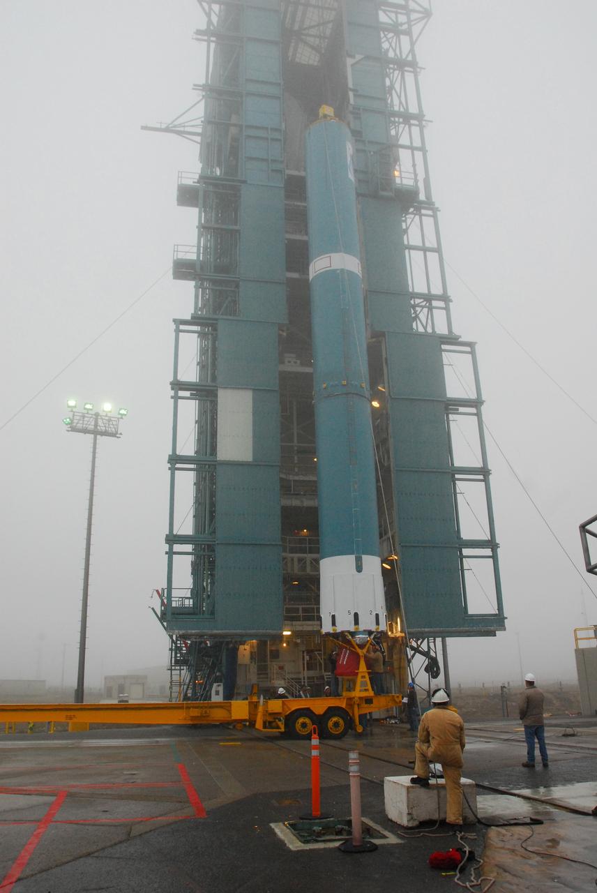 VANDENBERG AIR FORCE BASE, Calif. -- The first stage of a United Launch Alliance Delta II is lifted at NASA's Space Launch Complex-2 on Vandenberg Air Force Base in California. The rocket will carry NASA's National Polar-orbiting Operational Environmental Satellite System Preparatory Project (NPP) satellite into space.    NPP will be positioned 512 miles above the Earth's surface and will orbit about 16 times each day to observe nearly the entire globe. The NPP mission for NASA and the National Oceanic and Atmospheric Administration (NOAA) is to measure Earth's atmospheric and sea surface temperatures, humidity sounding, land and ocean biological activity, and cloud and aerosol properties. For more information, visit www.nasa.gov/NPP. Photo credit: NASA/VAFB, Mark Mackley