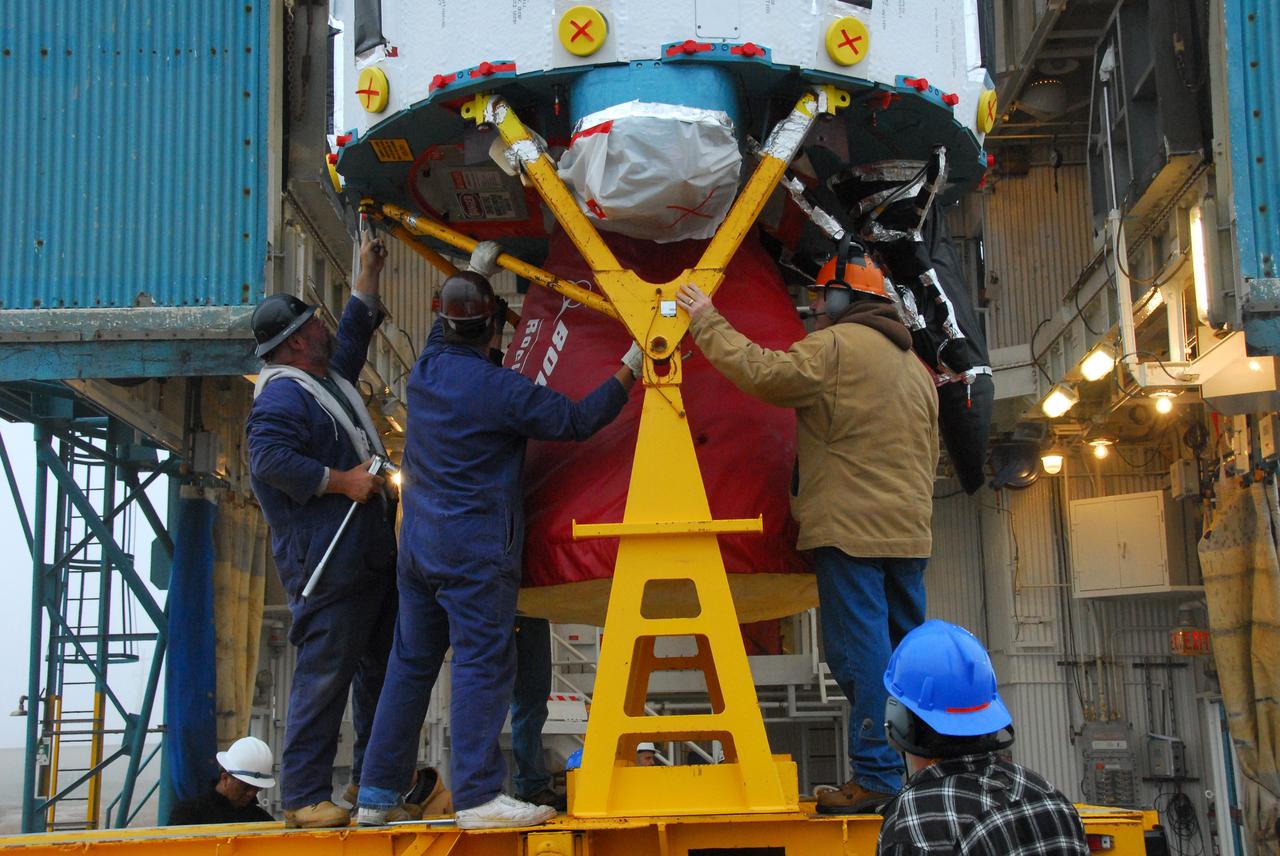 VANDENBERG AIR FORCE BASE, Calif. -- At NASA's Space Launch Complex-2 on Vandenberg Air Force Base in California, workers secure the Rocketdyne engine in the first stage of a United Launch Alliance Delta II. The rocket will carry NASA's National Polar-orbiting Operational Environmental Satellite System Preparatory Project (NPP) satellite into space.    NPP will be positioned 512 miles above the Earth's surface and will orbit about 16 times each day to observe nearly the entire globe. The NPP mission for NASA and the National Oceanic and Atmospheric Administration (NOAA) is to measure Earth's atmospheric and sea surface temperatures, humidity sounding, land and ocean biological activity, and cloud and aerosol properties. For more information, visit www.nasa.gov/NPP. Photo credit: NASA/VAFB, Mark Mackley