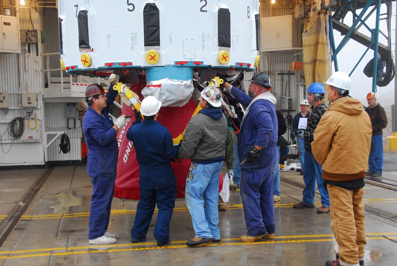 VANDENBERG AIR FORCE BASE, Calif. -- At NASA's Space Launch Complex-2 on Vandenberg Air Force Base in California, workers secure the Rocketdyne engine in the first stage of a United Launch Alliance Delta II. The rocket will carry NASA's National Polar-orbiting Operational Environmental Satellite System Preparatory Project (NPP) satellite into space.    NPP will be positioned 512 miles above the Earth's surface and will orbit about 16 times each day to observe nearly the entire globe. The NPP mission for NASA and the National Oceanic and Atmospheric Administration (NOAA) is to measure Earth's atmospheric and sea surface temperatures, humidity sounding, land and ocean biological activity, and cloud and aerosol properties. For more information, visit www.nasa.gov/NPP. Photo credit: NASA/VAFB, Mark Mackley