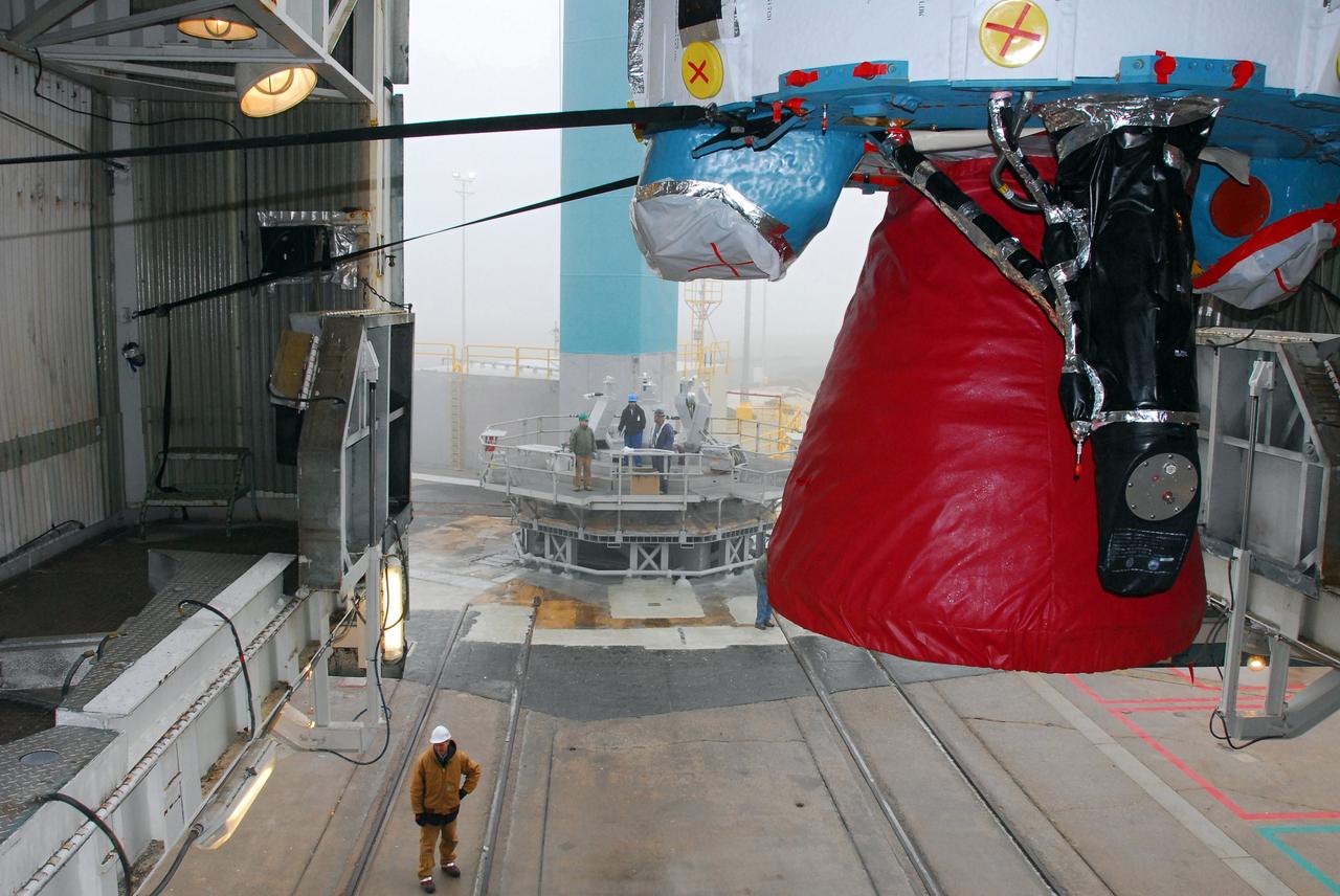 VANDENBERG AIR FORCE BASE, Calif. -- The first stage of a United Launch Alliance Delta II is hoisted into place at NASA's Space Launch Complex-2 on Vandenberg Air Force Base in California. Seen here in red is the Rocketdyne engine that will help loft the rocket off the pad. The rocket will carry NASA's National Polar-orbiting Operational Environmental Satellite System Preparatory Project (NPP) satellite into space.    NPP will be positioned 512 miles above the Earth's surface and will orbit about 16 times each day to observe nearly the entire globe. The NPP mission for NASA and the National Oceanic and Atmospheric Administration (NOAA) is to measure Earth's atmospheric and sea surface temperatures, humidity sounding, land and ocean biological activity, and cloud and aerosol properties. For more information, visit www.nasa.gov/NPP. Photo credit: NASA/VAFB, Mark Mackley